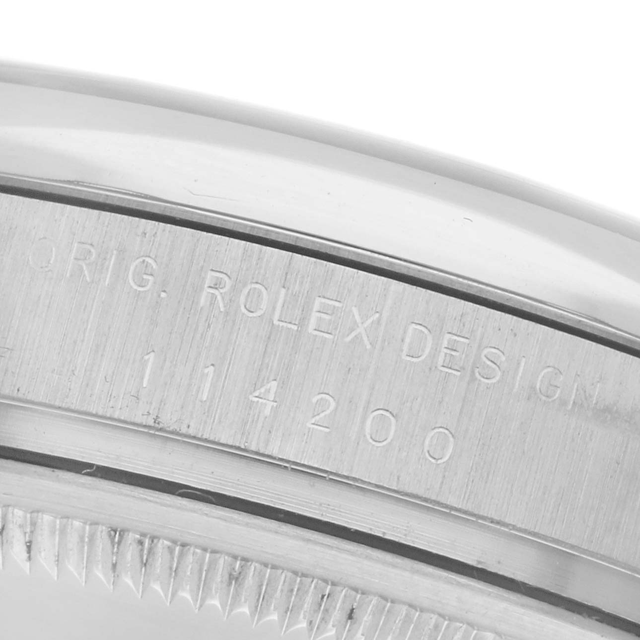 The image shows a close-up of the Rolex Air-King 114200 Men
s Stainless Steel Silver Dial 114200 Men
s Stainless Steel Silver Dial
s case, highlighting the engraved model number.