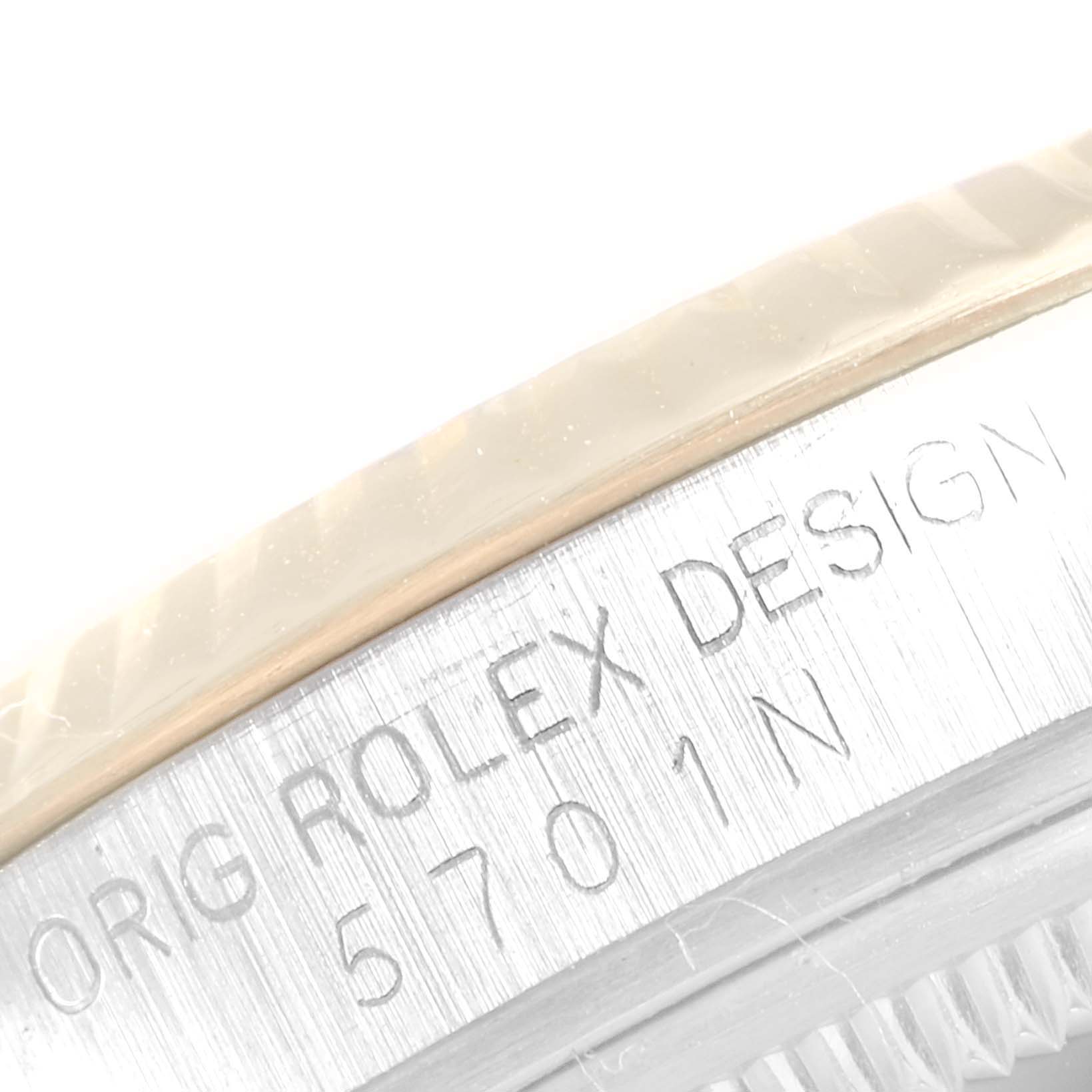 The image shows a close-up of the edge of the bezel and engraved case on a Rolex Vintage Collection 5701N Men's Steel and Gold (two tone) Champagne Dial 5701N Men's Steel and Gold (two tone) Champagne Dial model.