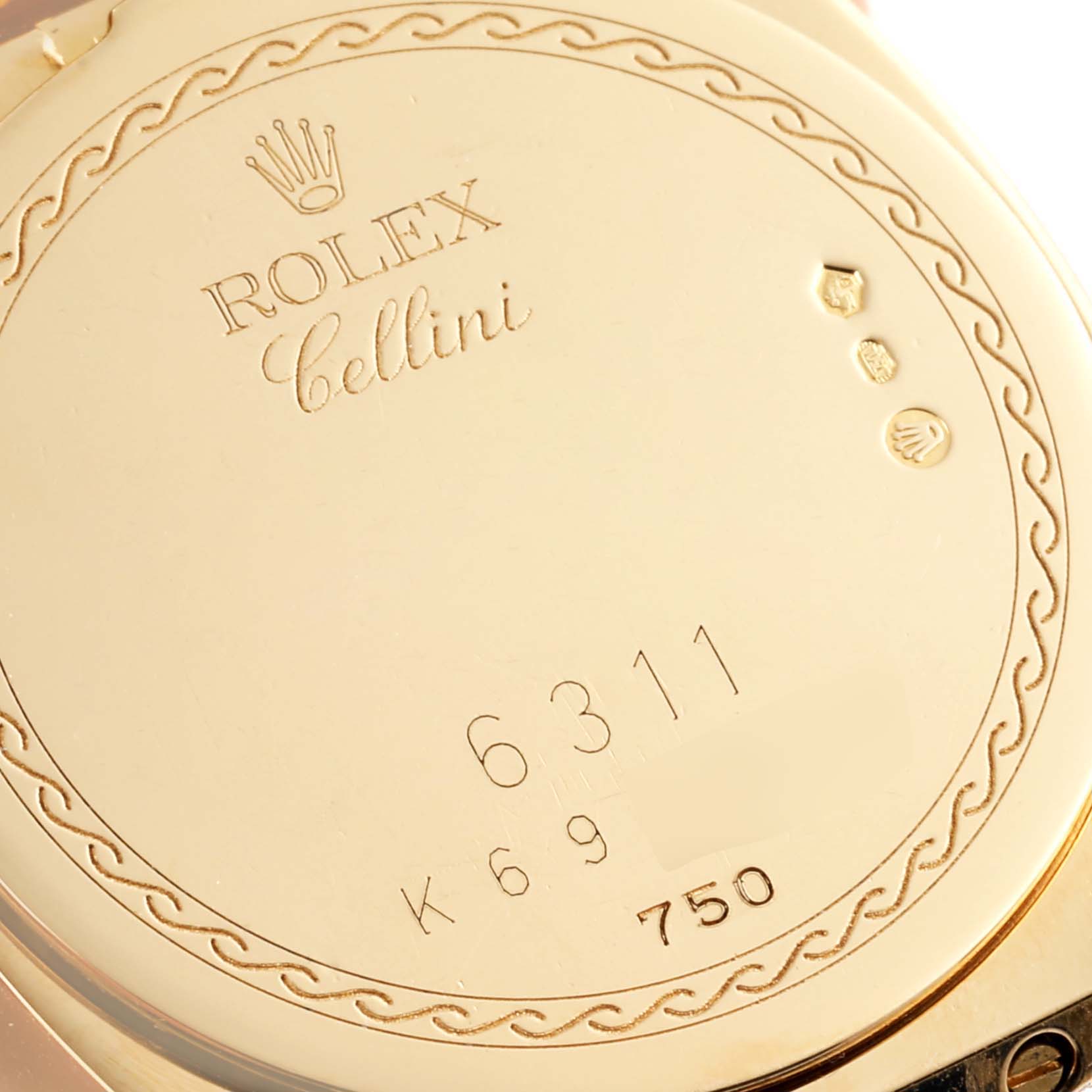 This image shows the engraved backside of a Rolex Cellini 6311 Women
s Yellow Gold White Dial 6311 Women
s Yellow Gold White Dial watch, featuring hallmark symbols and serial numbers.