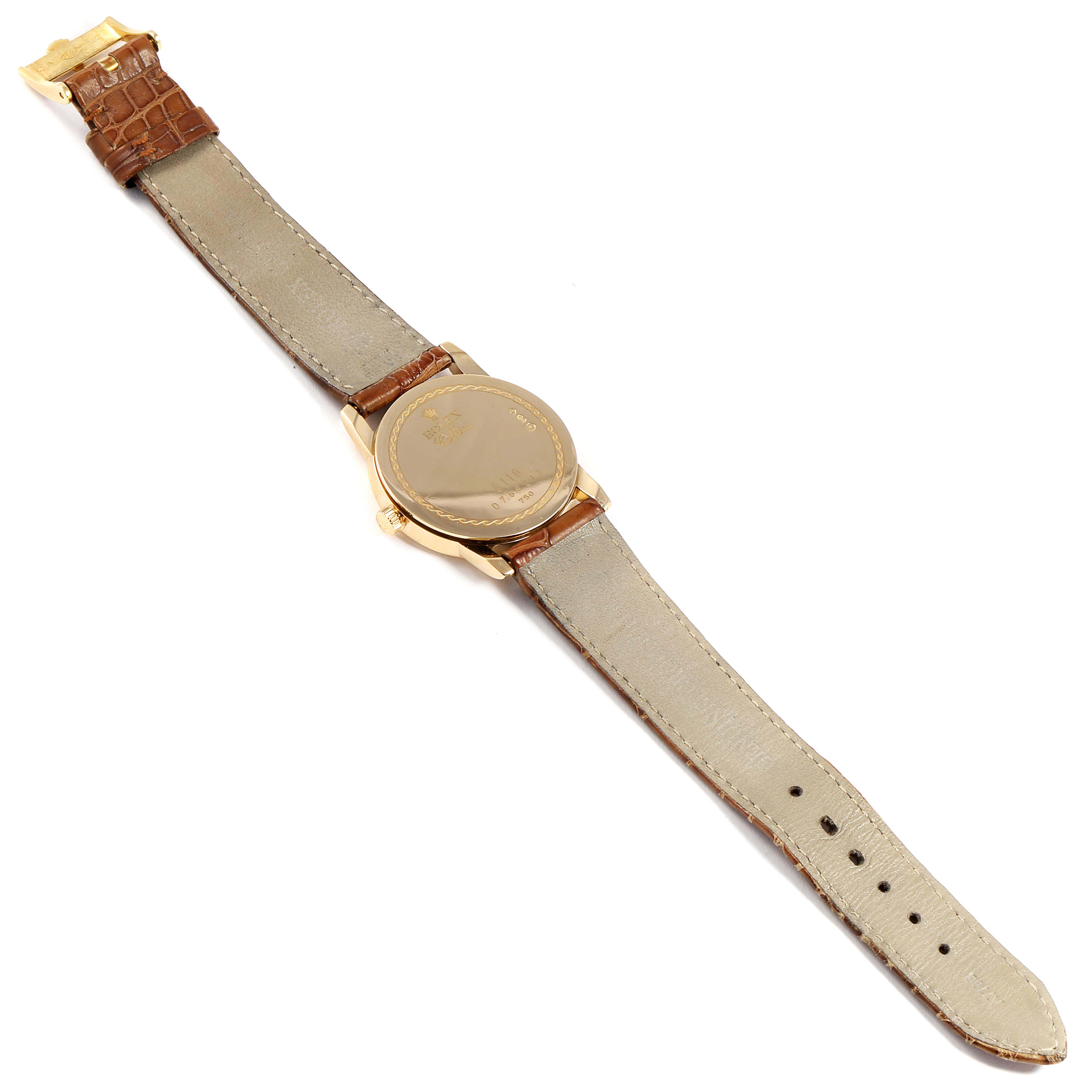 The Rolex Cellini 5116 Men's Yellow Gold Black Dial 5116 Men's Yellow Gold Black Dial watch is shown from the back angle, displaying its case back and brown leather strap with a gold clasp.