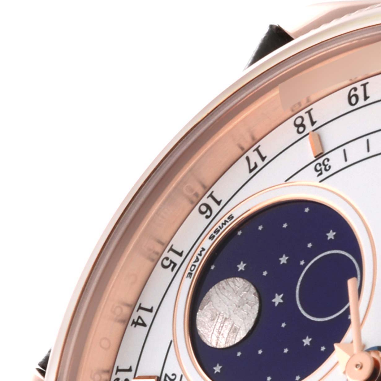 This close-up shows a partial view of the dial and moonphase indicator of a Rolex Cellini 50535 Men's Rose Gold White Dial 50535 Men's Rose Gold White Dial watch.
