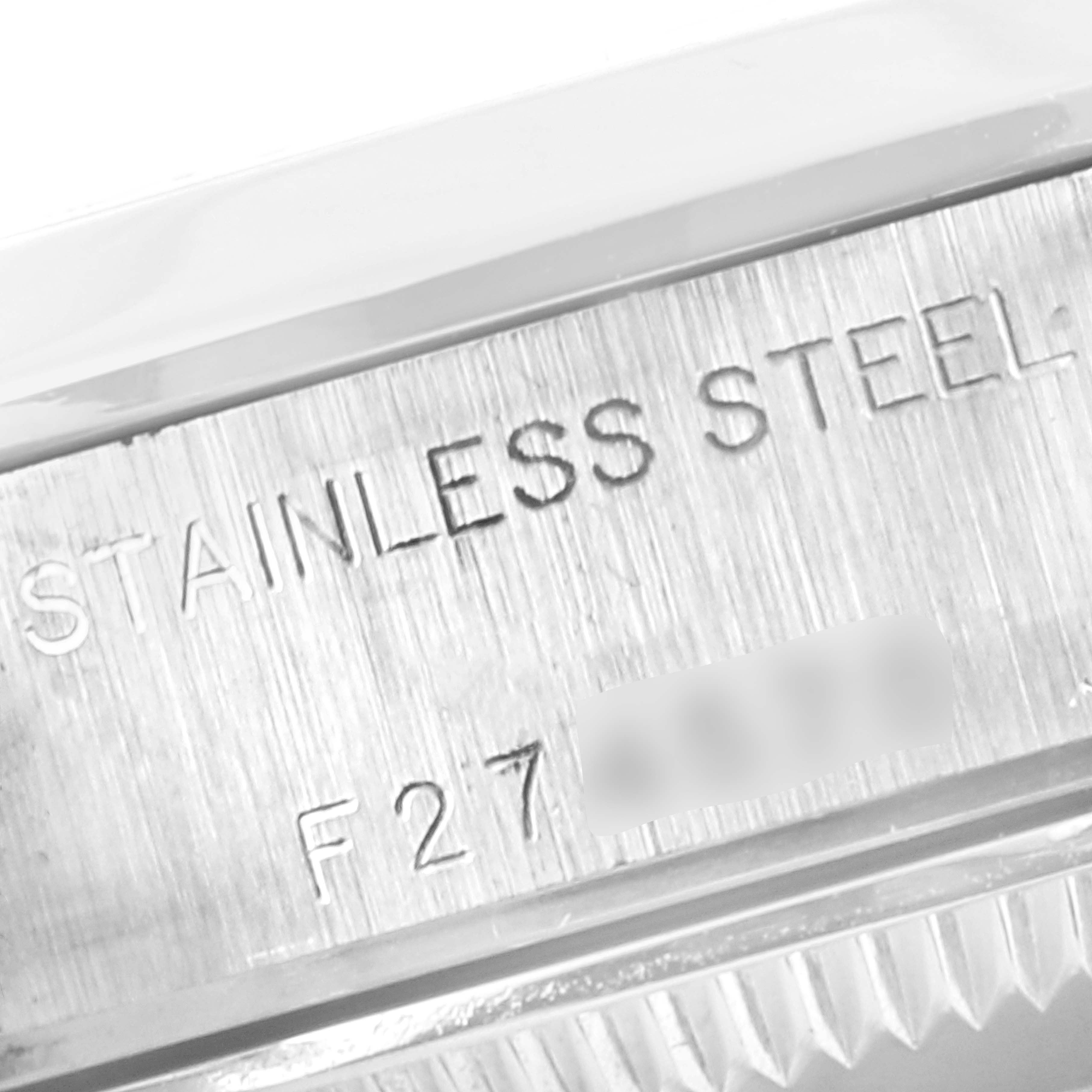 This close-up image shows the side of a Rolex Date 79160 Women's Stainless Steel Pink Dial 79160 Women's Stainless Steel Pink Dial model watch, highlighting the "STAINLESS STEEL" engraving.