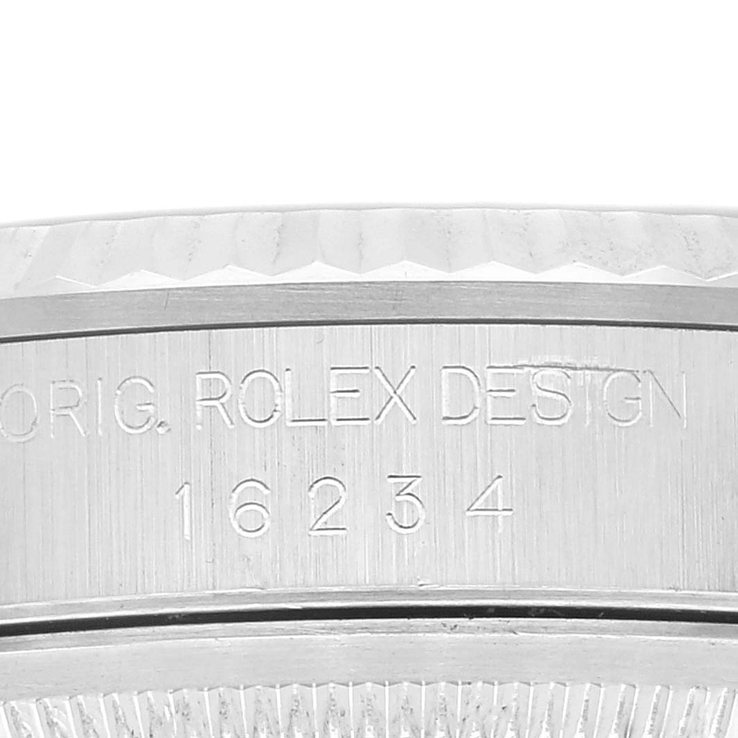 The image shows an angled close-up of a Rolex Datejust 16234 Men's Stainless Steel Black Dial 16234 Men's Stainless Steel Black Dial watch case with model number 16234 engraved.