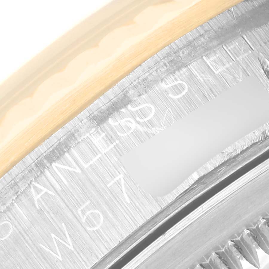 This close-up shows the case edge and part of the bezel inscription on a Rolex Datejust 16233 Men's Steel and Gold (two tone) Black Dial 16233 Men's Steel and Gold (two tone) Black Dial watch.