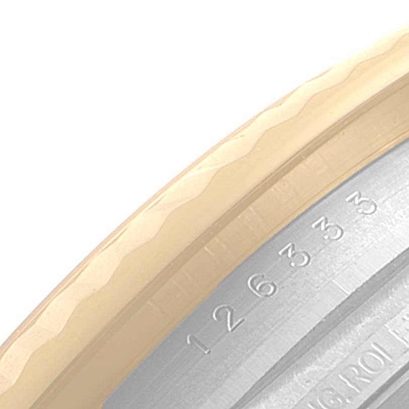 This image shows a close-up of the serial number engraving on the bezel of a Rolex Datejust 41 126333 Men's Steel and Gold (two tone) Black Dial 126333 Men's Steel and Gold (two tone) Black Dial watch.