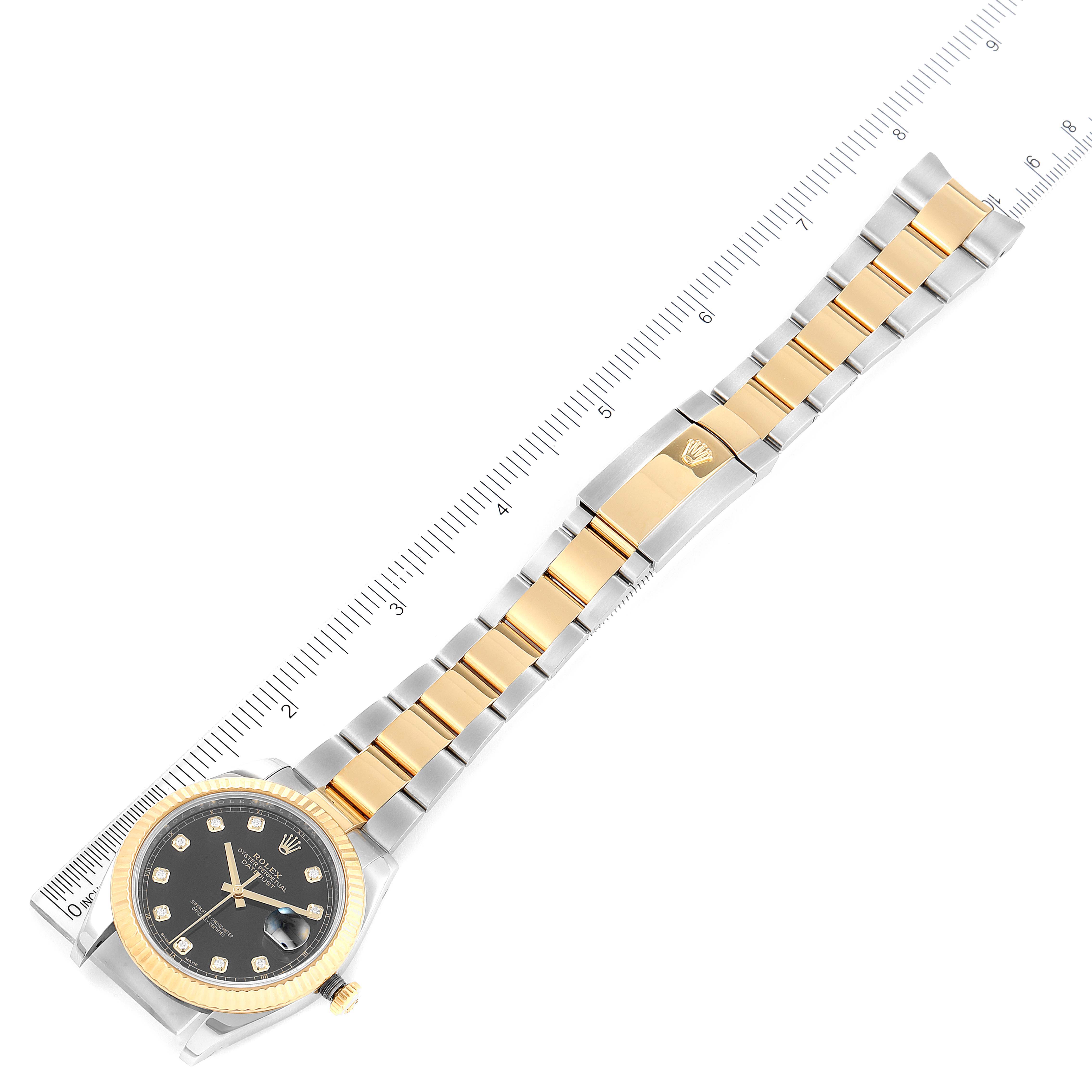 The image shows a Rolex Datejust 41 126333 Men's Steel and Gold (two tone) Black Dial 126333 Men's Steel and Gold (two tone) Black Dial watch laid flat, displaying the face, bezel, and bracelet, alongside a ruler for scale.