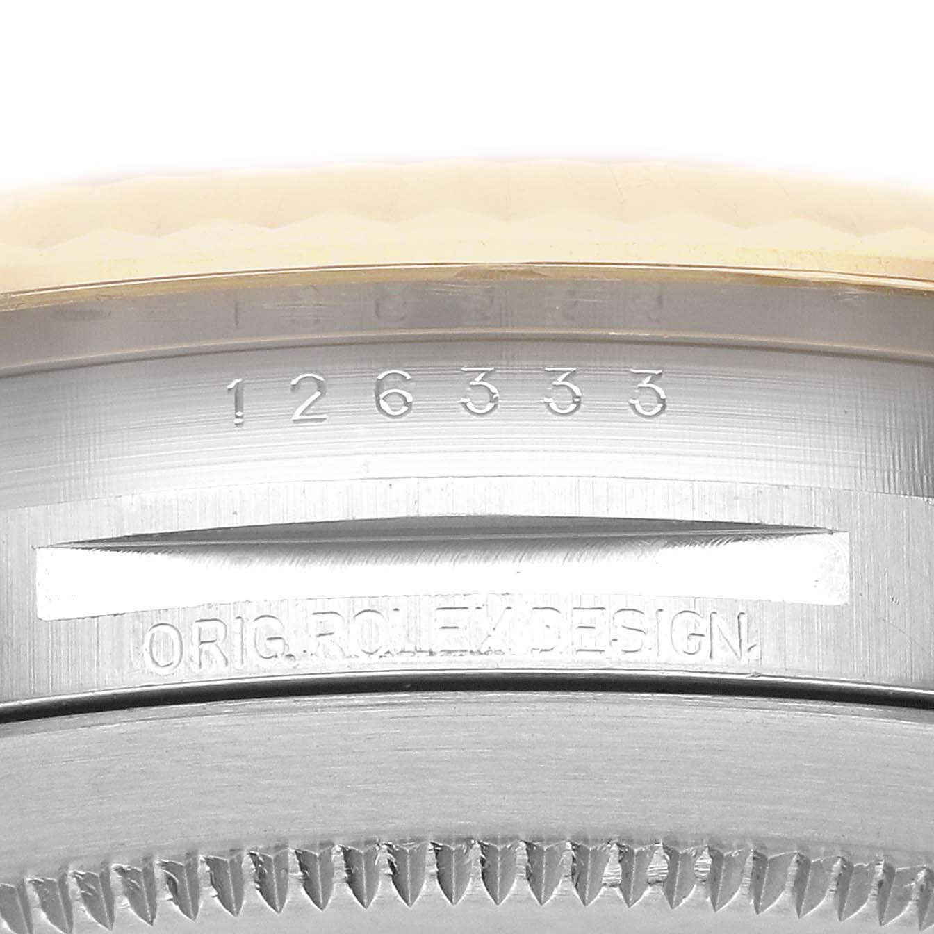 The image shows a close-up view of the serial number and "Orig. Rolex Design" engraving on the case of a Rolex Datejust 41 M126333-0011 Men's Steel and Gold (two tone) Champagne Dial M126333-0011 Men's Steel and Gold (two tone) Champagne Dial watch.