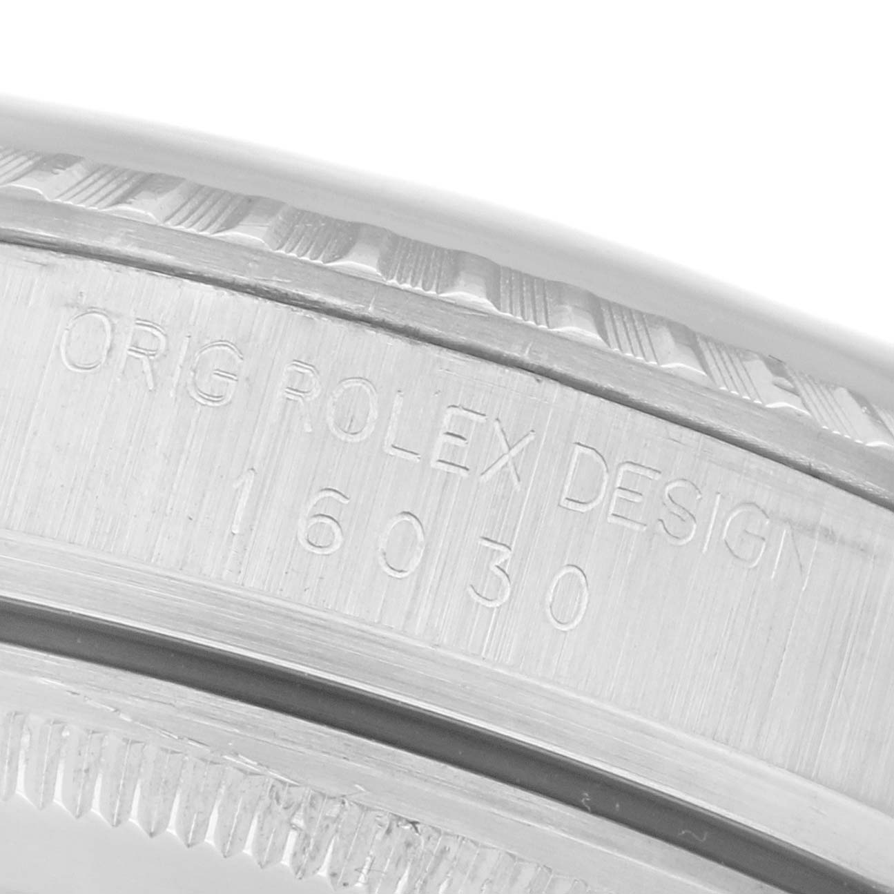 The image shows an angled close-up of a Rolex Datejust 16030 Men
s Stainless Steel Silver Dial 16030 Men
s Stainless Steel Silver Dial
s case side, with engraving visible.