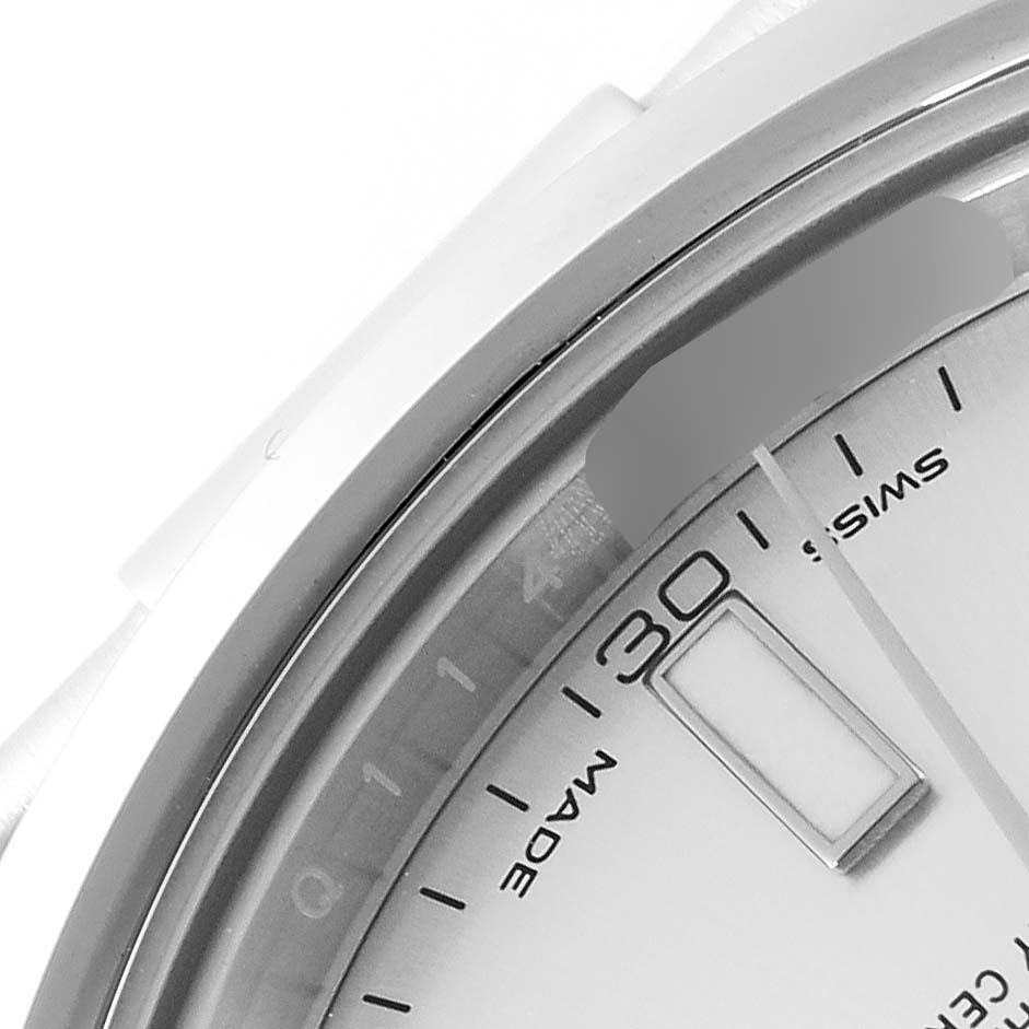 The image shows a close-up of the Rolex Datejust 116300 Men
s Stainless Steel Silver Dial 116300 Men
s Stainless Steel Silver Dial watch, focusing on the bezel, part of the dial, and the date window at 3 o
clock.