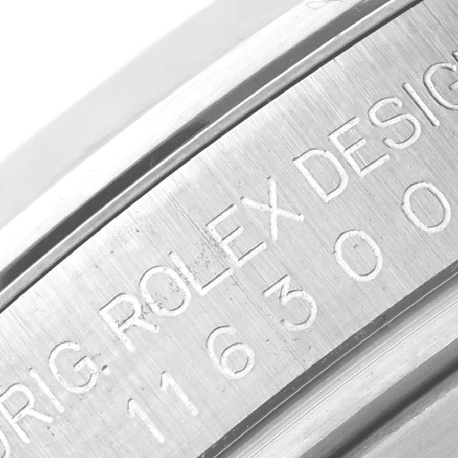 The image shows a close-up view of the engraved watch casing of a Rolex Datejust 116300 Men
s Stainless Steel Silver Dial 116300 Men
s Stainless Steel Silver Dial model.