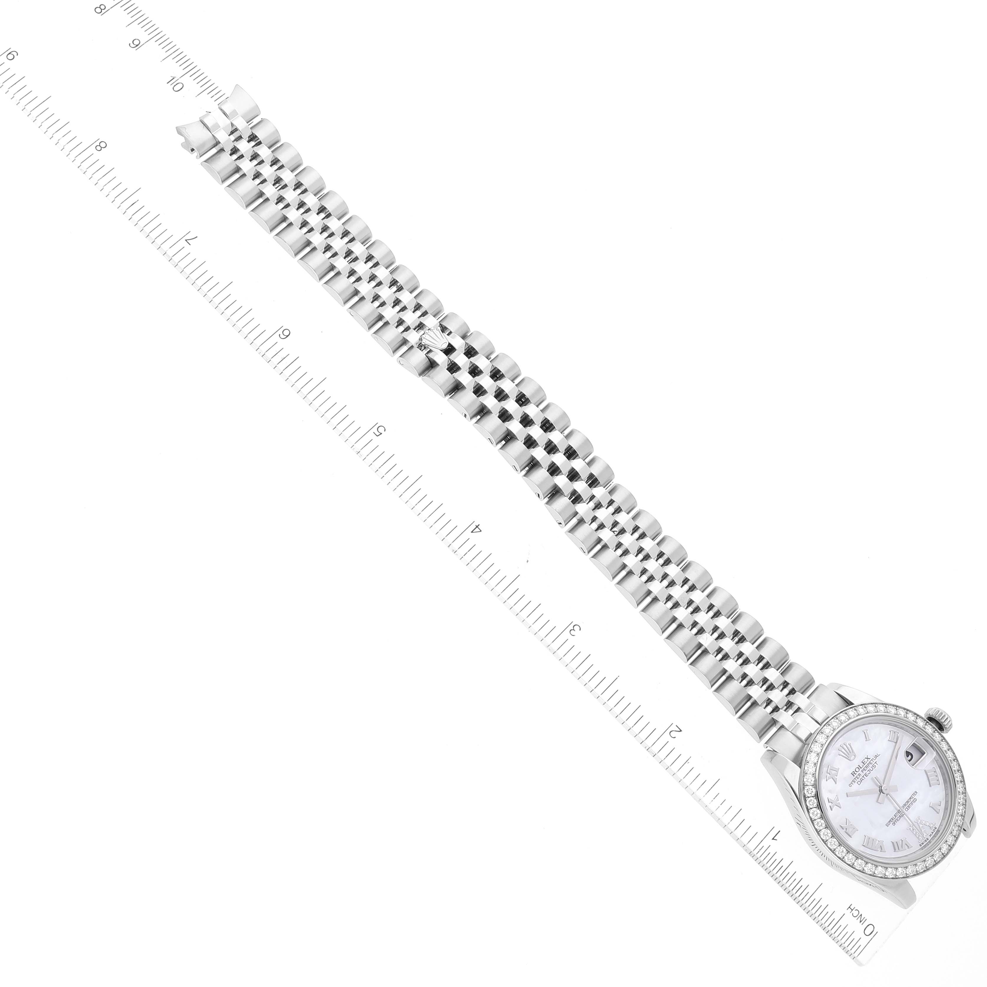 The image shows a top-down view of a Mid-Size Rolex watch featuring the face and the entire bracelet aligned with a ruler.