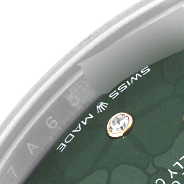 The image shows a close-up of the dial and bezel of a Mid-Size Rolex watch, highlighting "SWISS MADE" and a diamond marker.