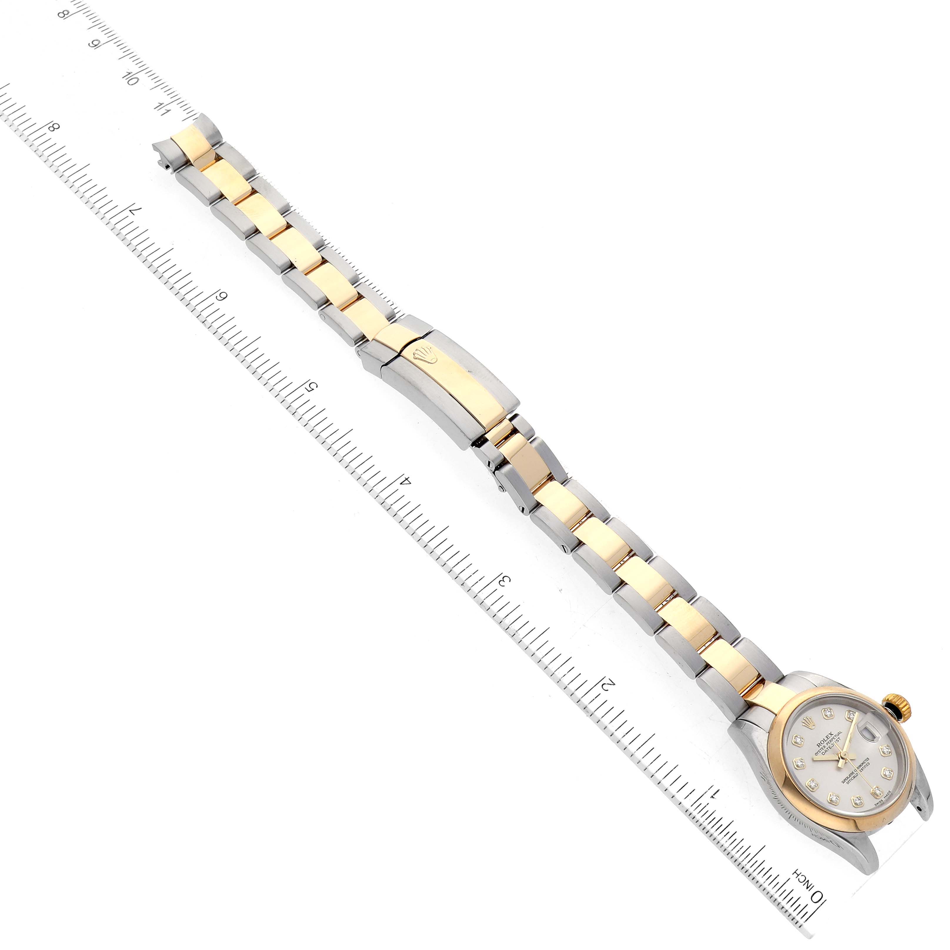 The image shows a Rolex Datejust 179163 Women's Steel and Gold (two tone) Silver Dial 179163 Women's Steel and Gold (two tone) Silver Dial watch laid flat with a ruler alongside for scale, highlighting the bracelet and clasp.