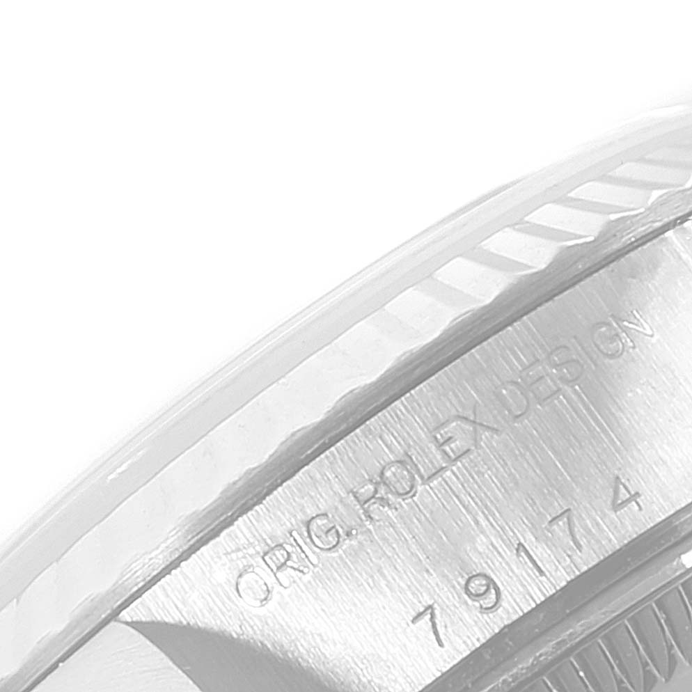 This image shows a close-up of the bezel and case side of a Rolex Datejust 79174 Women's Stainless Steel Silver Dial 79174 Women's Stainless Steel Silver Dial watch, showcasing the engraved text.