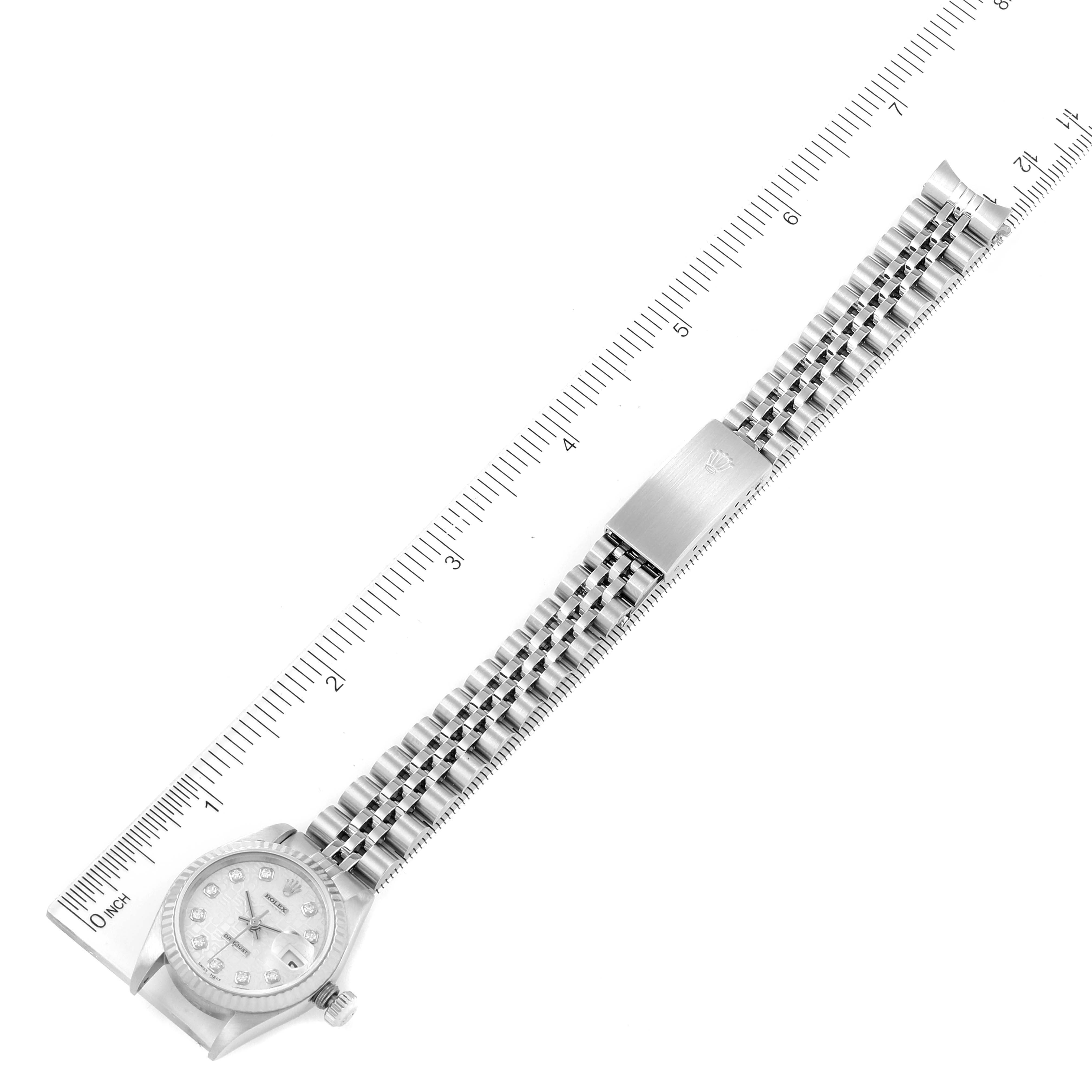 This image shows a Rolex Datejust 79174 Women's Stainless Steel Silver Dial 79174 Women's Stainless Steel Silver Dial watch in top view, featuring its face, bezel, bracelet, and clasp, with rulers for scale.