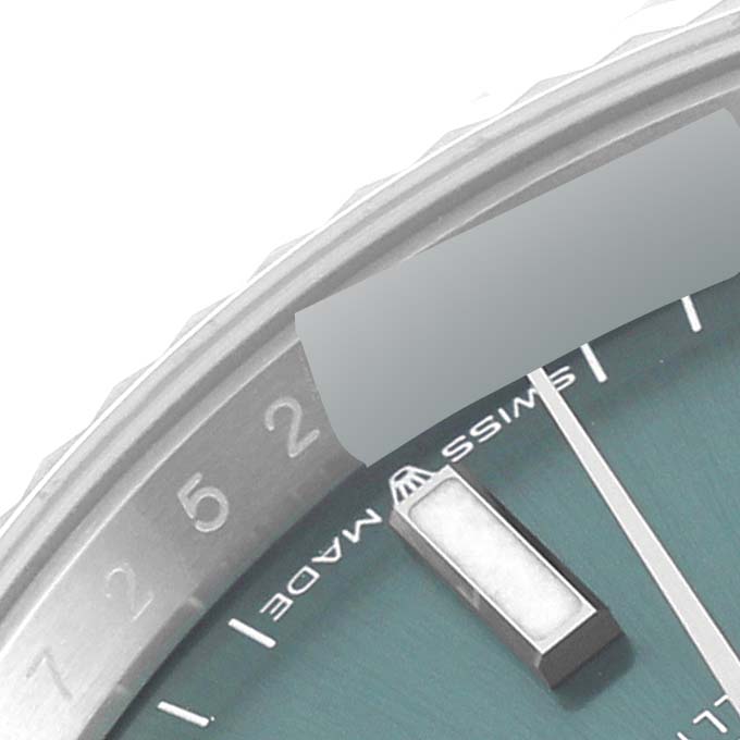This close-up shot of the Rolex Datejust 126234 Men's Stainless Steel Green Dial 126234 Men's Stainless Steel Green Dial shows a portion of the watch face, including the bezel, markers, and part of the dial.