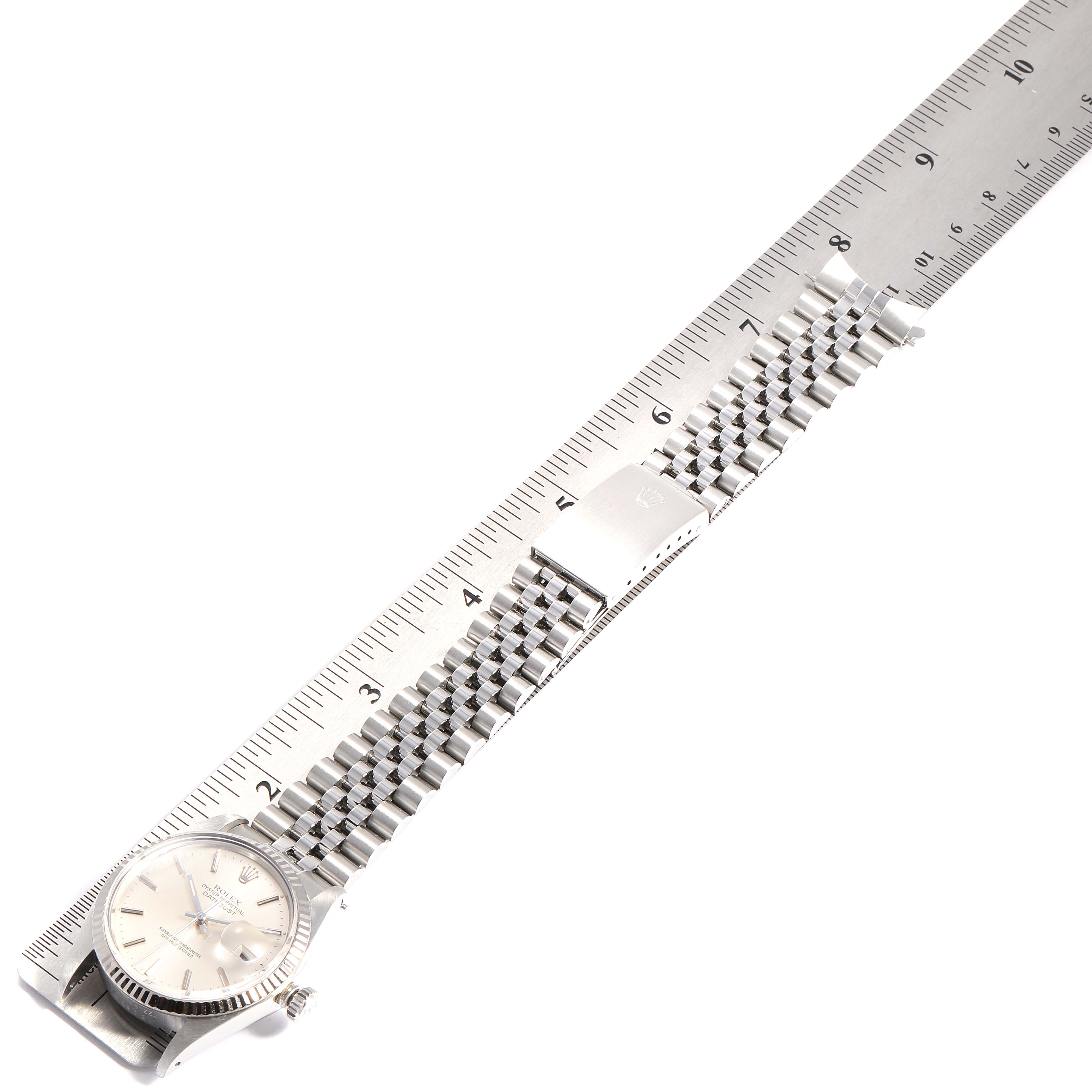 The image shows the face and full metal strap of the Rolex Vintage Collection 16014 Men
s Stainless Steel Silver Dial 16014 Men
s Stainless Steel Silver Dial watch, measured against a ruler.