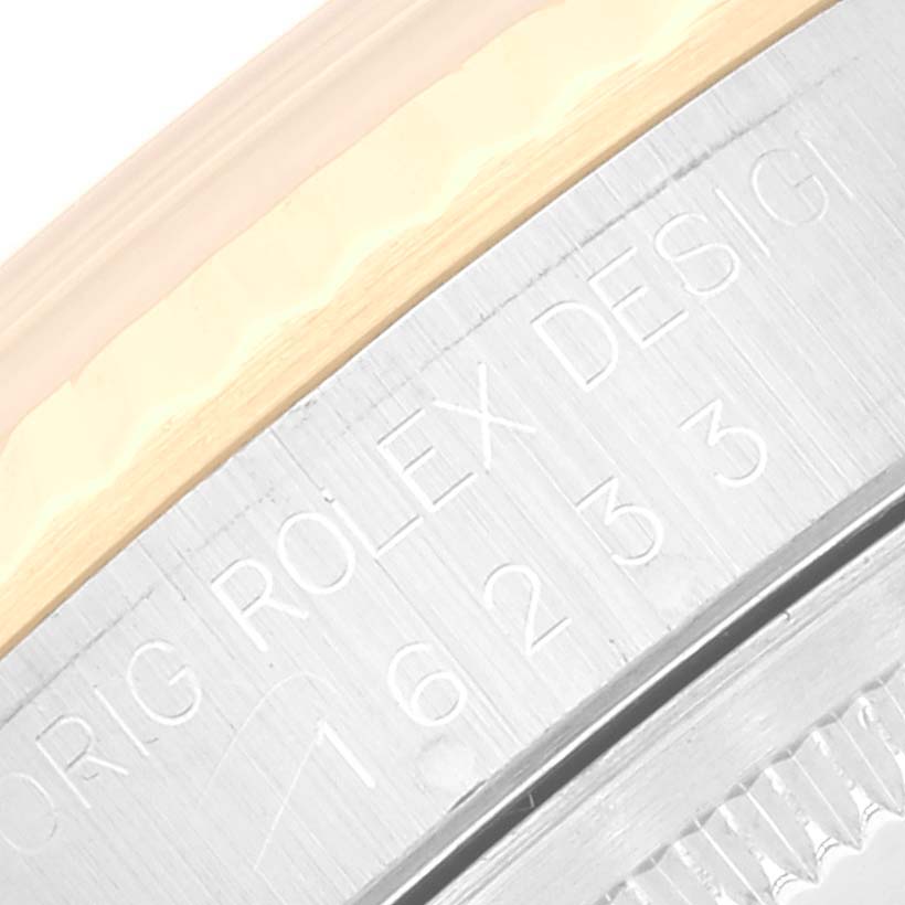 The image shows a close-up of the side engraving and bezel of a Rolex Datejust 16233 Men's Steel and Gold (two tone) Blue Dial 16233 Men's Steel and Gold (two tone) Blue Dial watch.
