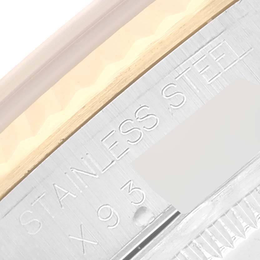 This image shows a close-up of the side of a Rolex Datejust 16233 Men's Steel and Gold (two tone) Blue Dial 16233 Men's Steel and Gold (two tone) Blue Dial watch, focusing on the "STAINLESS STEEL" engraving.
