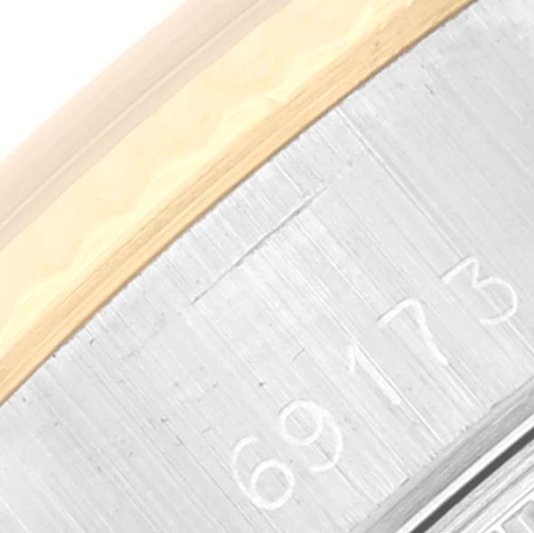 The image shows a close-up view of the case side and serial number of a Rolex Datejust 69173 Women's Steel and Gold (two tone) Champagne Dial 69173 Women's Steel and Gold (two tone) Champagne Dial watch.