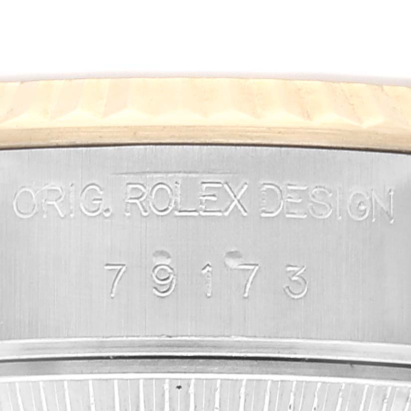The image shows a close-up of the case side of a Rolex Datejust 79173 Women's Steel and Gold (two tone) Champagne Dial 79173 Women's Steel and Gold (two tone) Champagne Dial, highlighting the engraved model number and "Orig. Rolex Design" text.