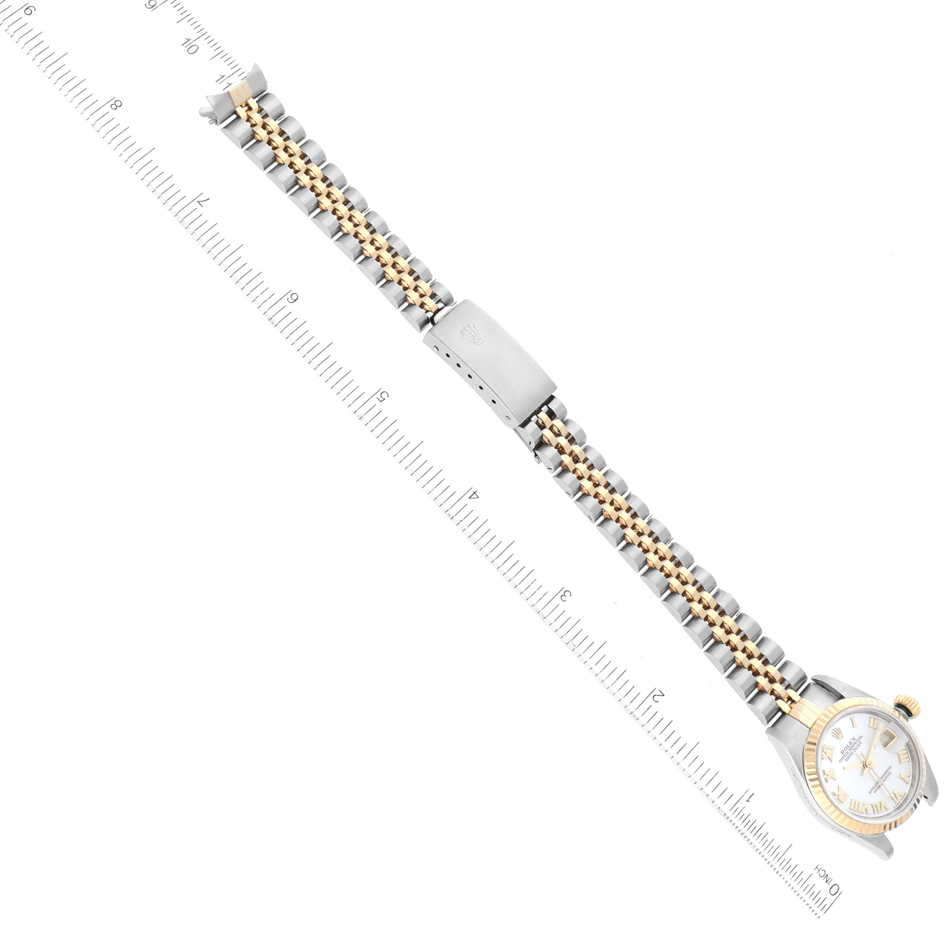 The image shows a top-down view of a Rolex Datejust 79173NR Women's Steel and Gold (two tone) Mother of Pearl Dial 79173NR Women's Steel and Gold (two tone) Mother of Pearl Dial watch, displaying the face, bracelet, and clasp alongside a measuring ruler.