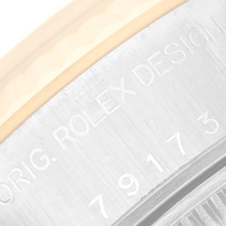 The image shows an angled close-up of the case back edge of a Rolex Datejust 79173NR Women's Steel and Gold (two tone) Mother of Pearl Dial 79173NR Women's Steel and Gold (two tone) Mother of Pearl Dial watch, displaying the model and brand engraving.