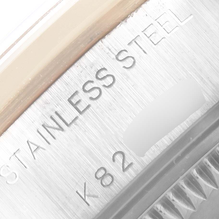 The image shows a close-up of the case side of the Rolex Datejust 79163 Women's Steel and Gold (two tone) Grey Dial 79163 Women's Steel and Gold (two tone) Grey Dial, focusing on the "STAINLESS STEEL" engraving.