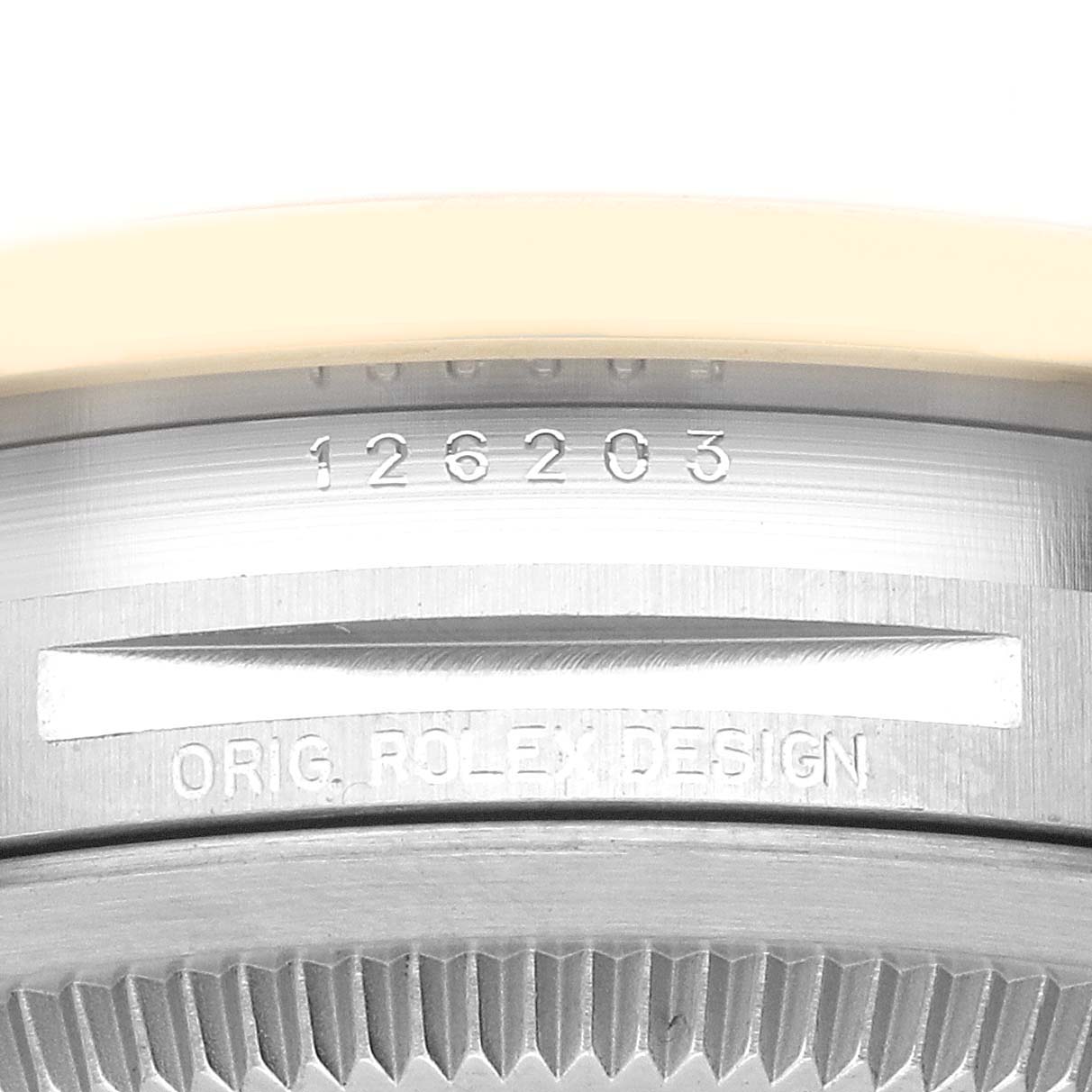 This close-up image shows the model number and "Orig. Rolex Design" engraving on the case of a Rolex Datejust 126203 Men
s Steel and Gold (two tone) Grey Dial 126203 Men
s Steel and Gold (two tone) Grey Dial watch.