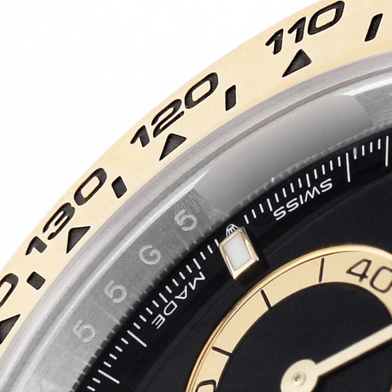 The image shows a close-up of the Rolex Daytona 126503 Men's Steel and Gold (two tone) Black Dial bezel and part of the dial with visible markings and numbers.