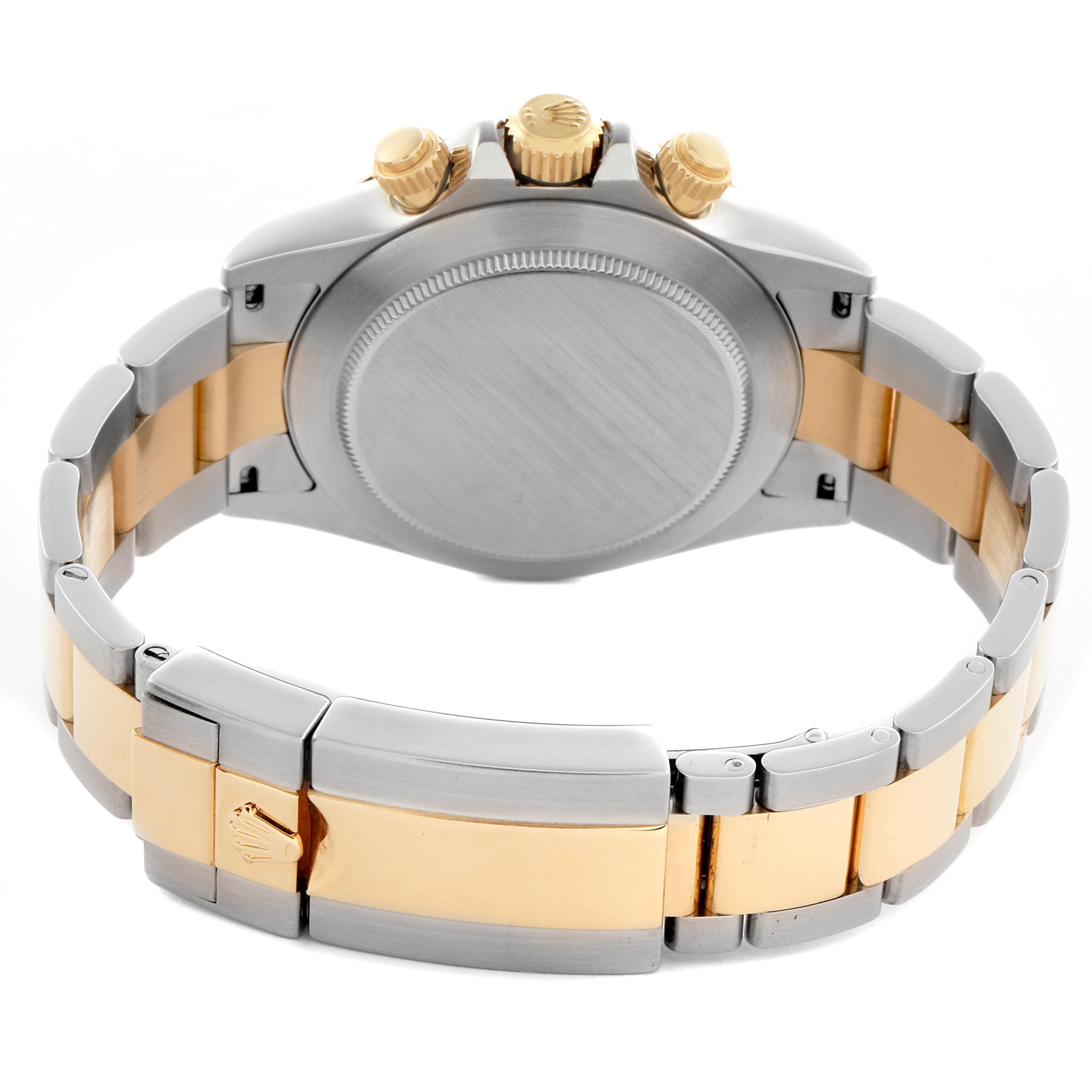 The image shows the back of a Rolex Daytona 116523 Men
s Steel and Gold (two tone) Mother of Pearl Dial 116523 Men
s Steel and Gold (two tone) Mother of Pearl Dial watch, highlighting its case, bracelet, clasp, and crown from a rear angle.