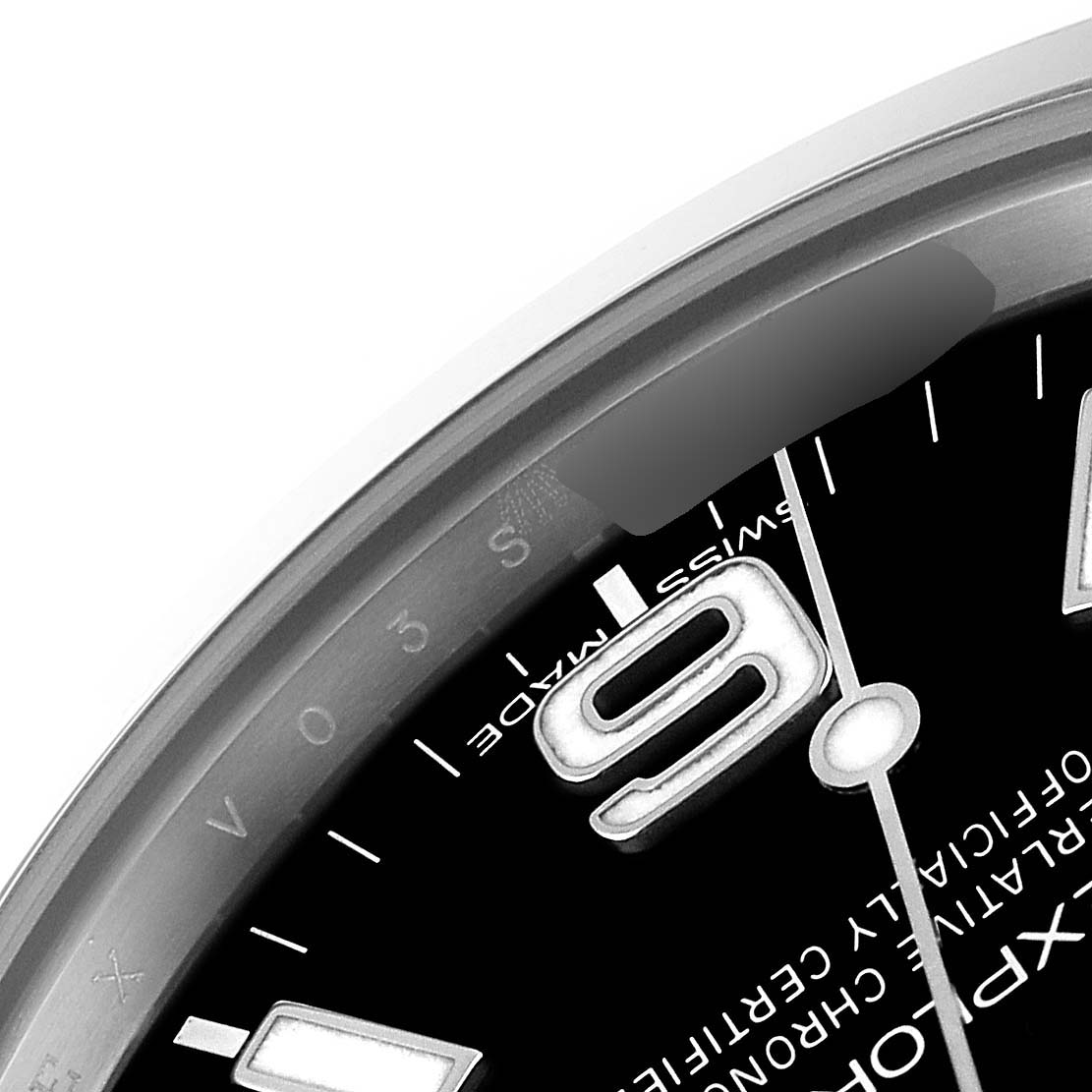 This image shows a close-up of the dial and bezel of a Rolex Explorer 214270 Men
s Stainless Steel Black Dial 214270 Men
s Stainless Steel Black Dial watch, displaying the number "9" and part of the minute and hour hands.