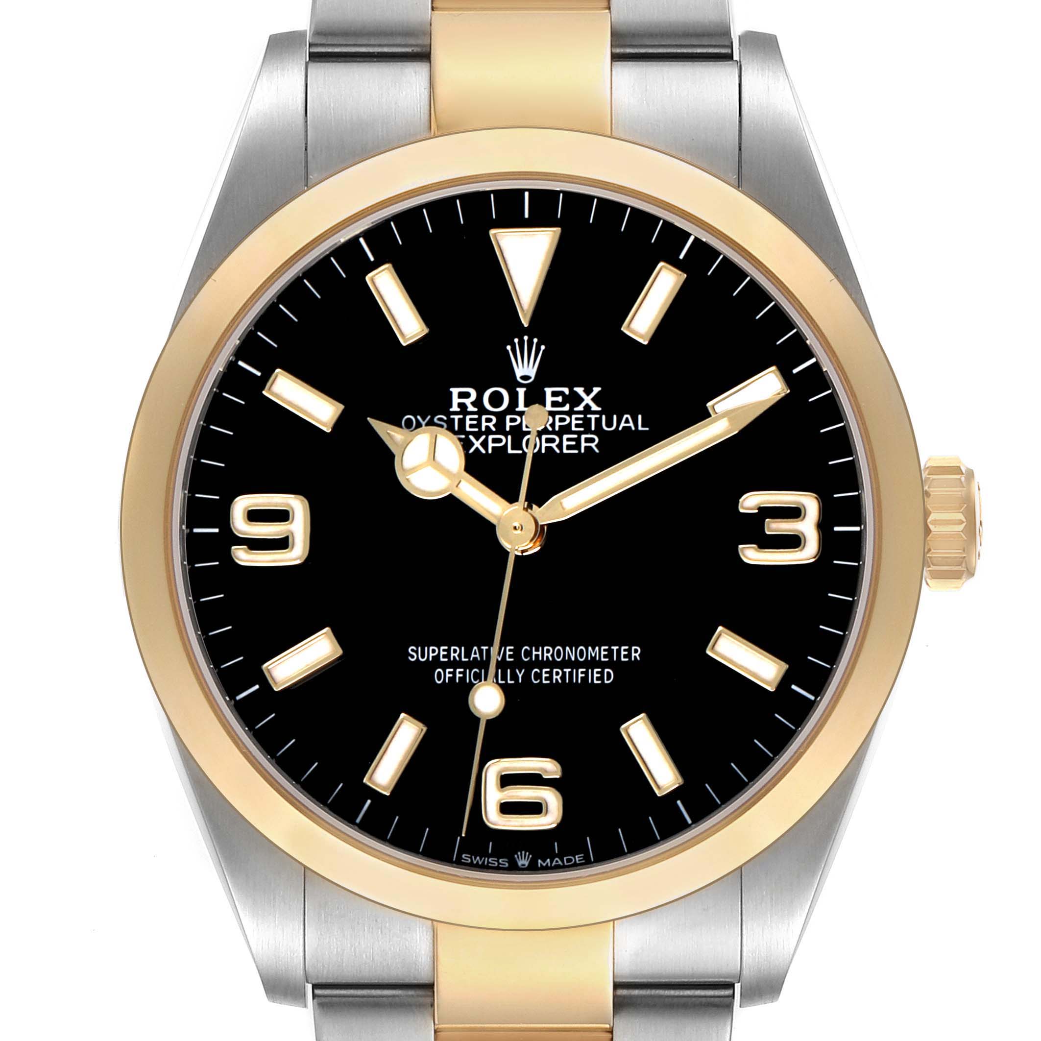 The image shows a front view of the Rolex Explorer 124273 Men's Steel and Gold (two tone) Black Dial watch, highlighting its bezel, dial, markers, and crown.