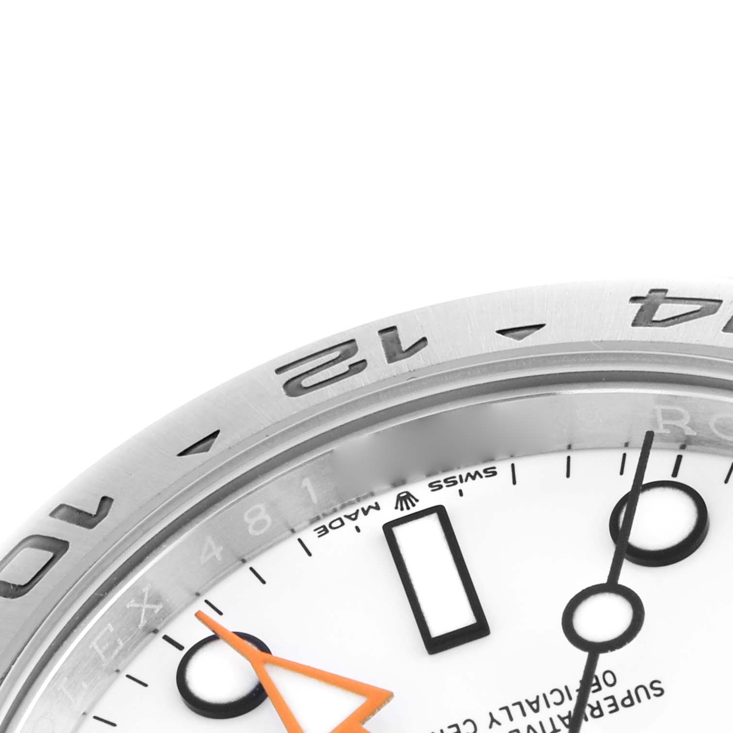 The image shows a close-up of the top-right section of the Rolex Explorer 226570 Men
s Stainless Steel White Dial 226570 Men
s Stainless Steel White Dial watch, featuring part of the bezel, dial, and hour markers.