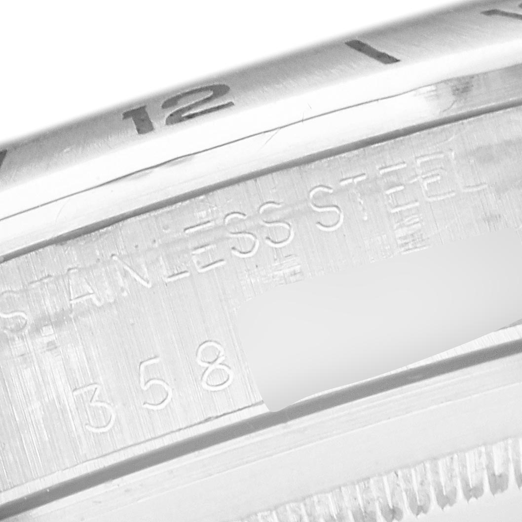 The image shows a close-up of the Rolex Explorer 1655 Men
s Stainless Steel Black Dial 1655 Men
s Stainless Steel Black Dial watch
s inner bezel and part of the casing, featuring engravings.