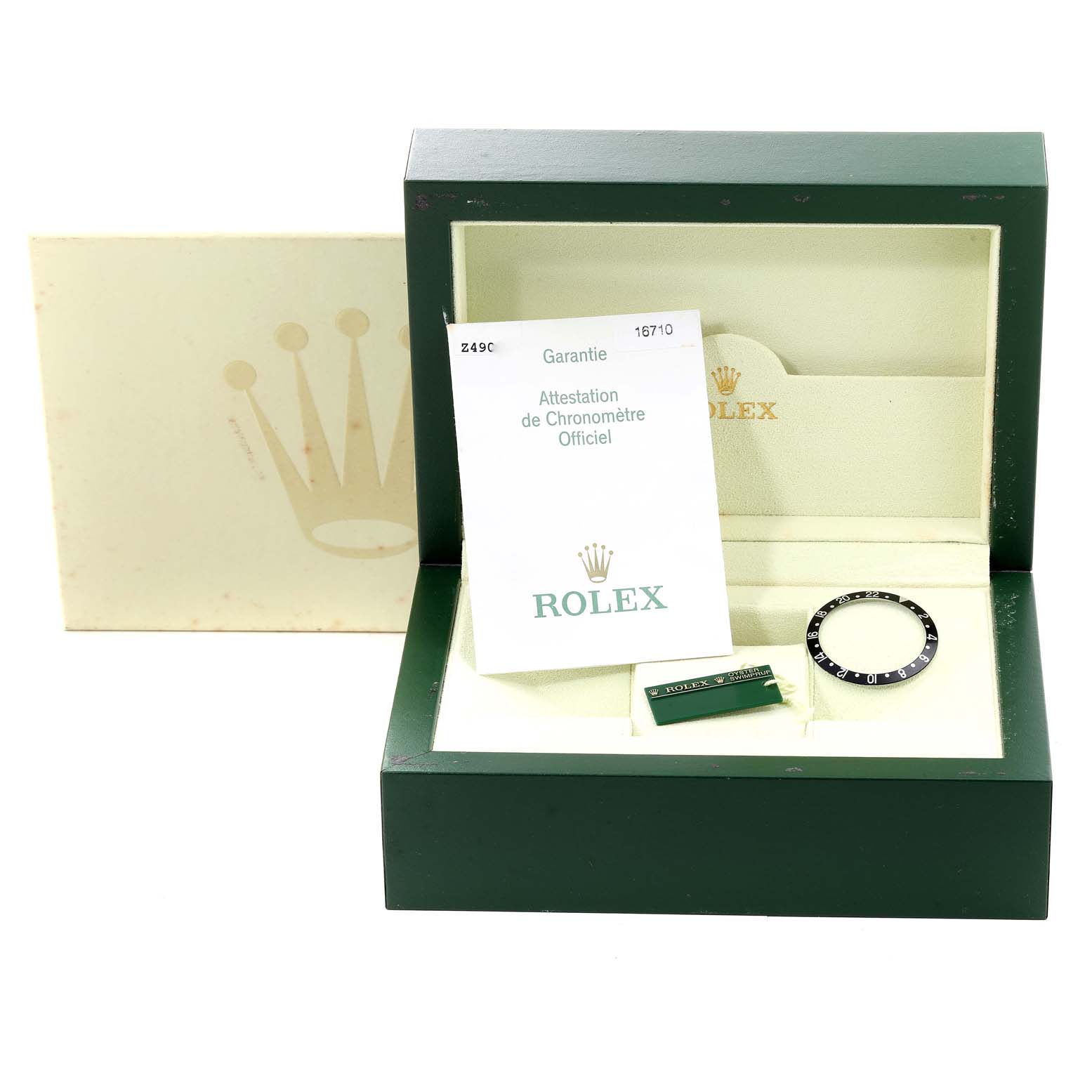This image shows a Rolex GMT-Master 16710 Men
s Stainless Steel Black Dial 16710 Men
s Stainless Steel Black Dial watch box with a bezel, documentation, and a tag from a top-down angle.