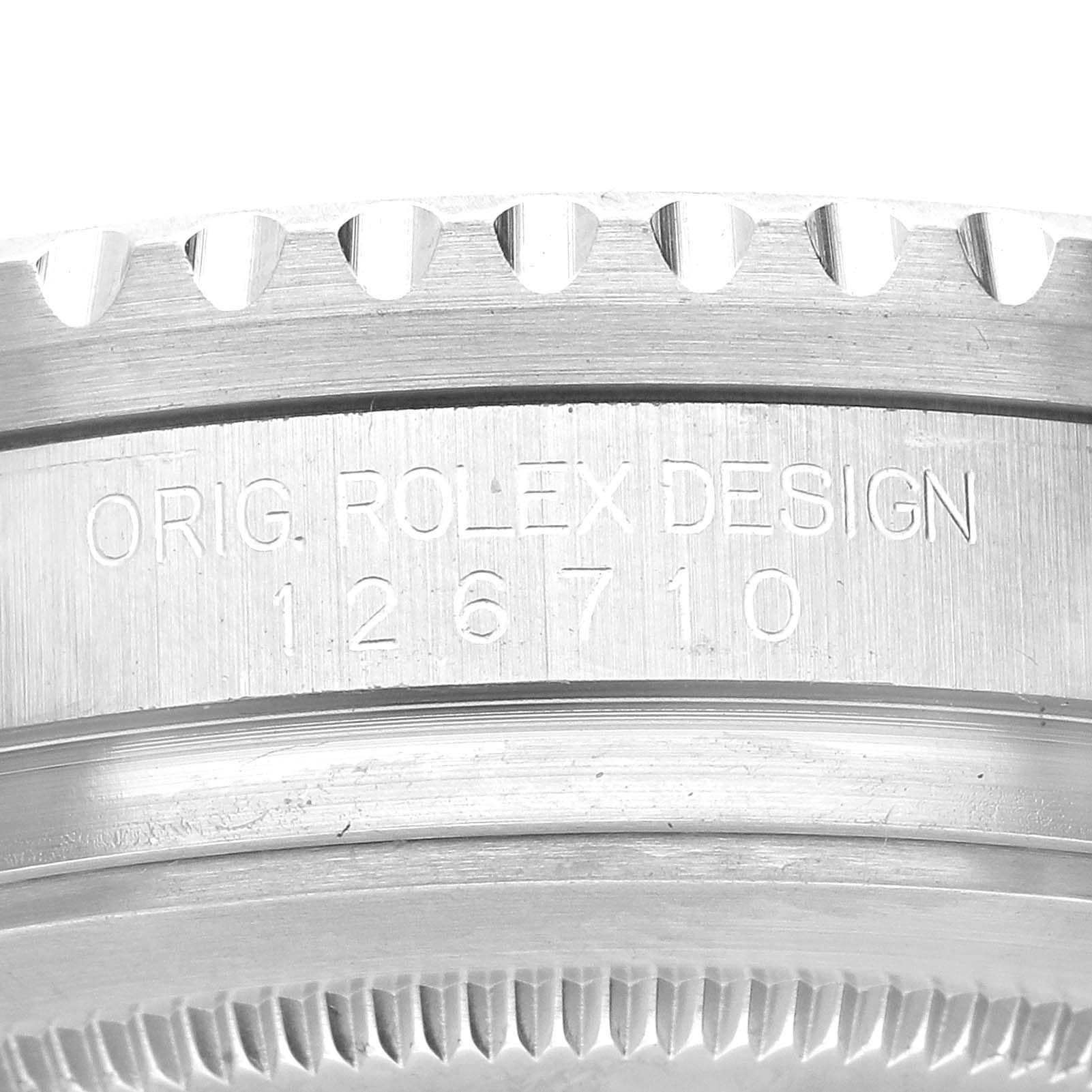 This image shows a close-up of the side of a Rolex GMT-Master 126710BLRO Men's Stainless Steel Black Dial 126710BLRO Men's Stainless Steel Black Dial watch, prominently displaying the "ORIG. ROLEX DESIGN" engraving and model number 126710.