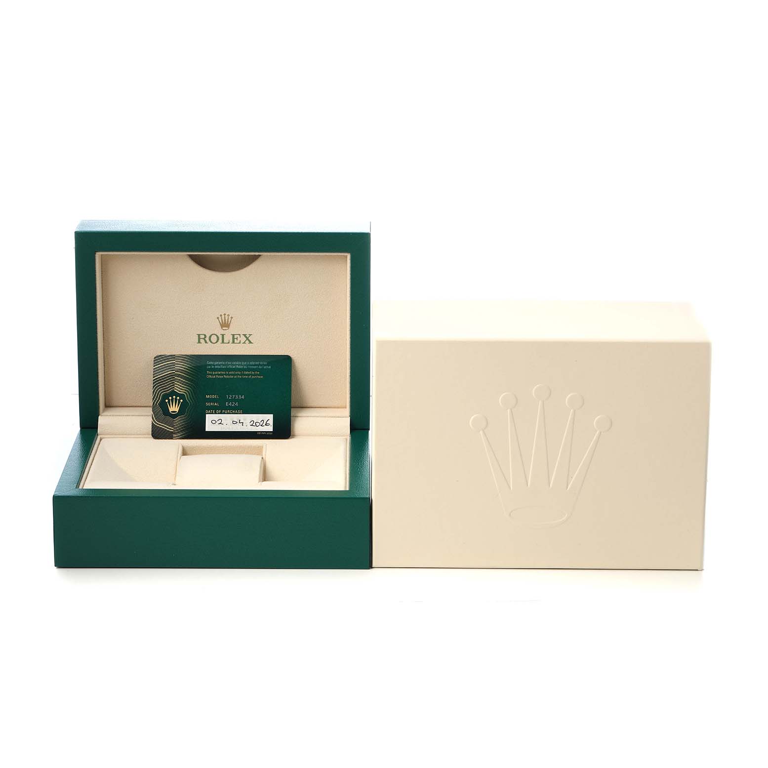 The image shows a Rolex Land-Dweller watch box open with a warranty card inside, alongside a closed outer box.