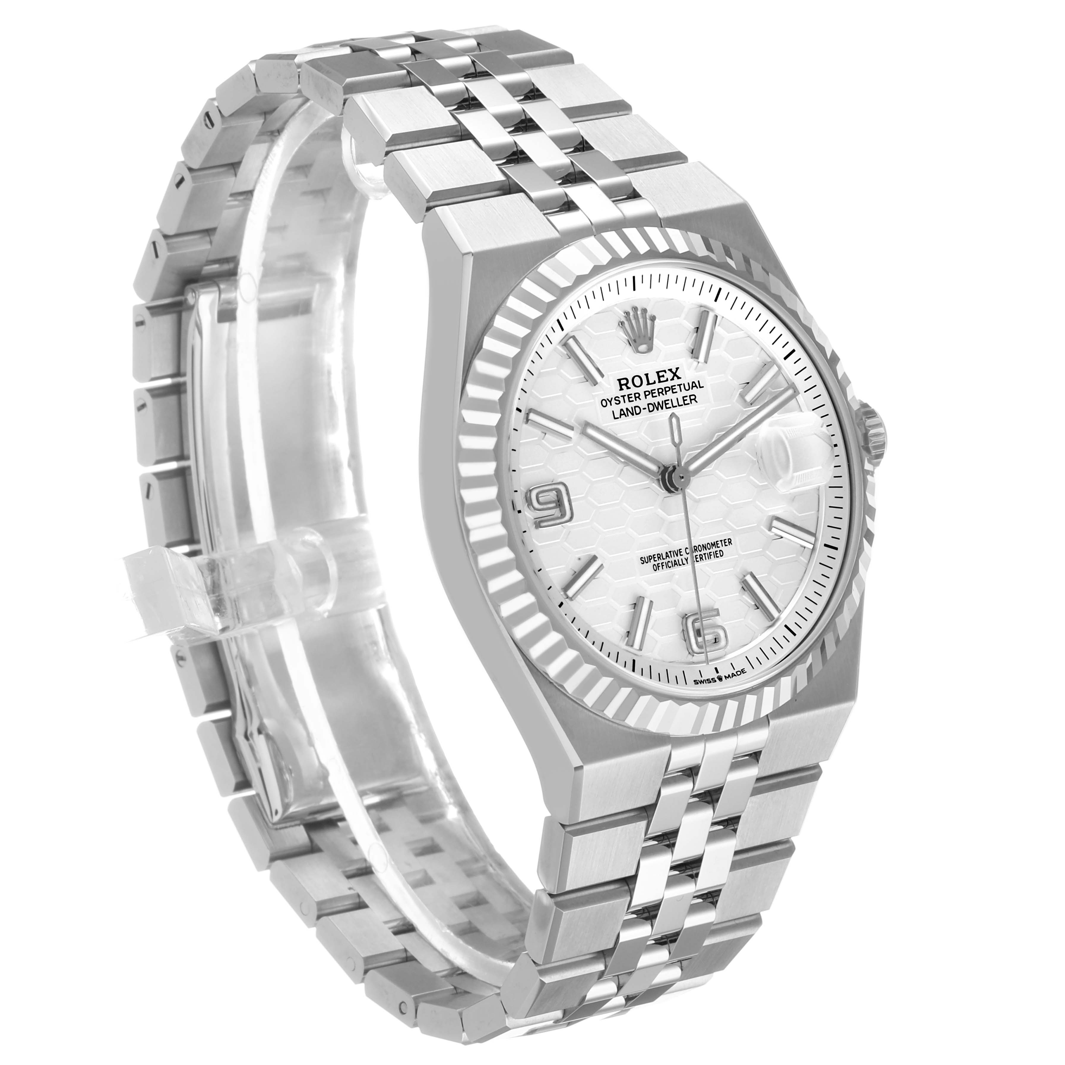 The Rolex Land-Dweller watch is shown at an angle highlighting the face, bezel, and bracelet.