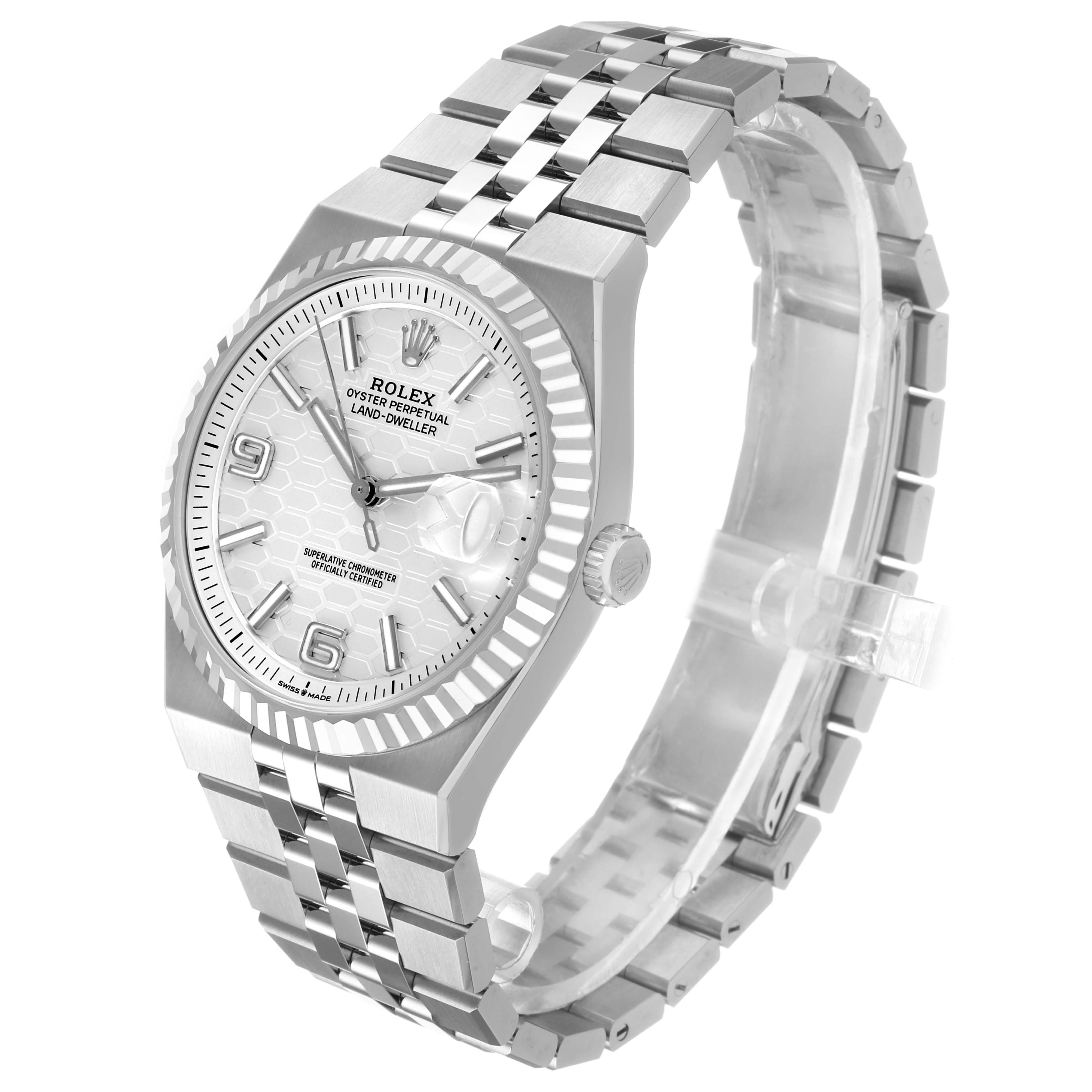 The Rolex Land‑Dweller 127334 Men's Stainless Steel White Dial watch is shown at an oblique angle, displaying the face, bezel, crown, and bracelet clearly.