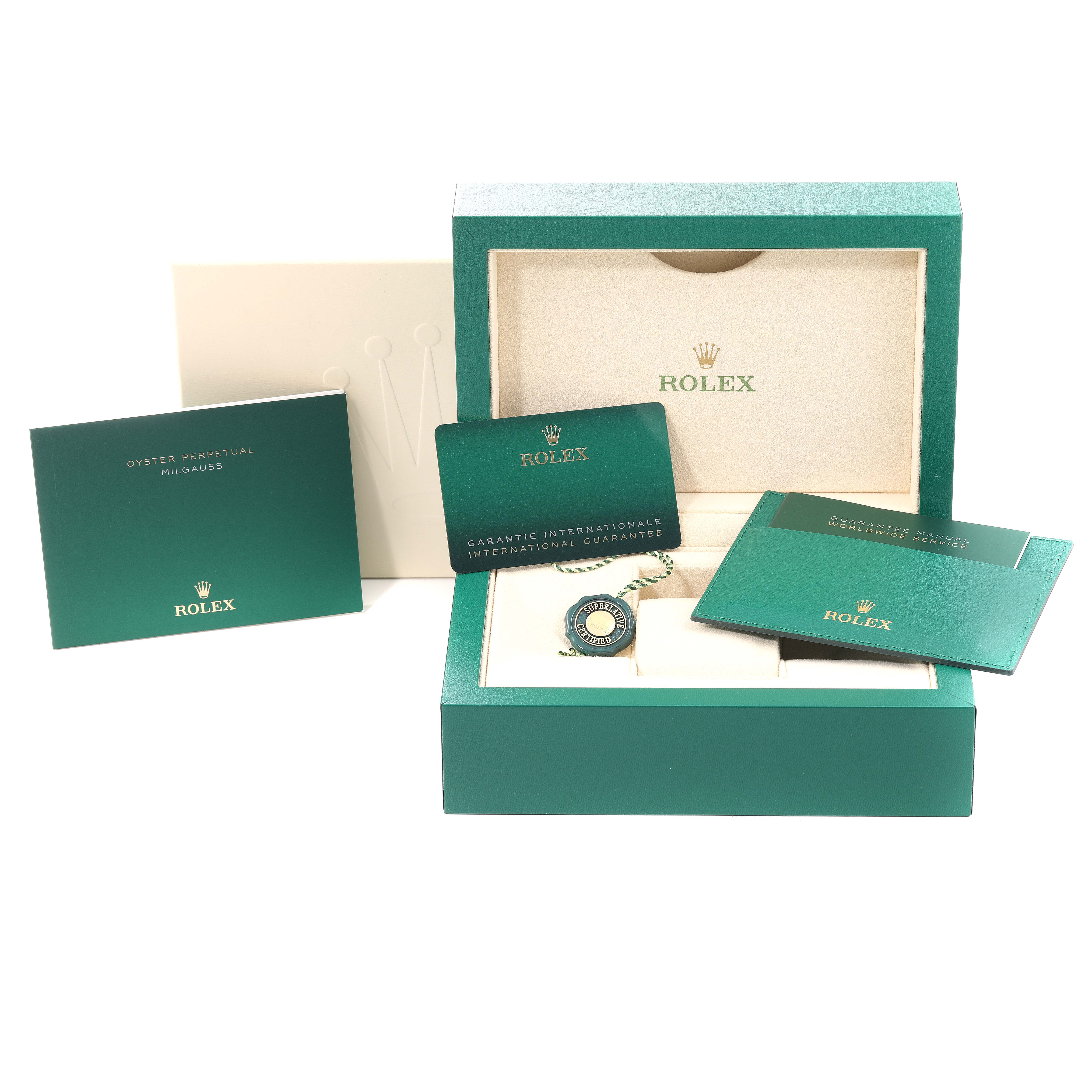 The image shows a Rolex Milgauss 116400 Men
s Stainless Steel Blue Dial 116400 Men
s Stainless Steel Blue Dial watch box with warranty cards, a tag, and manuals.