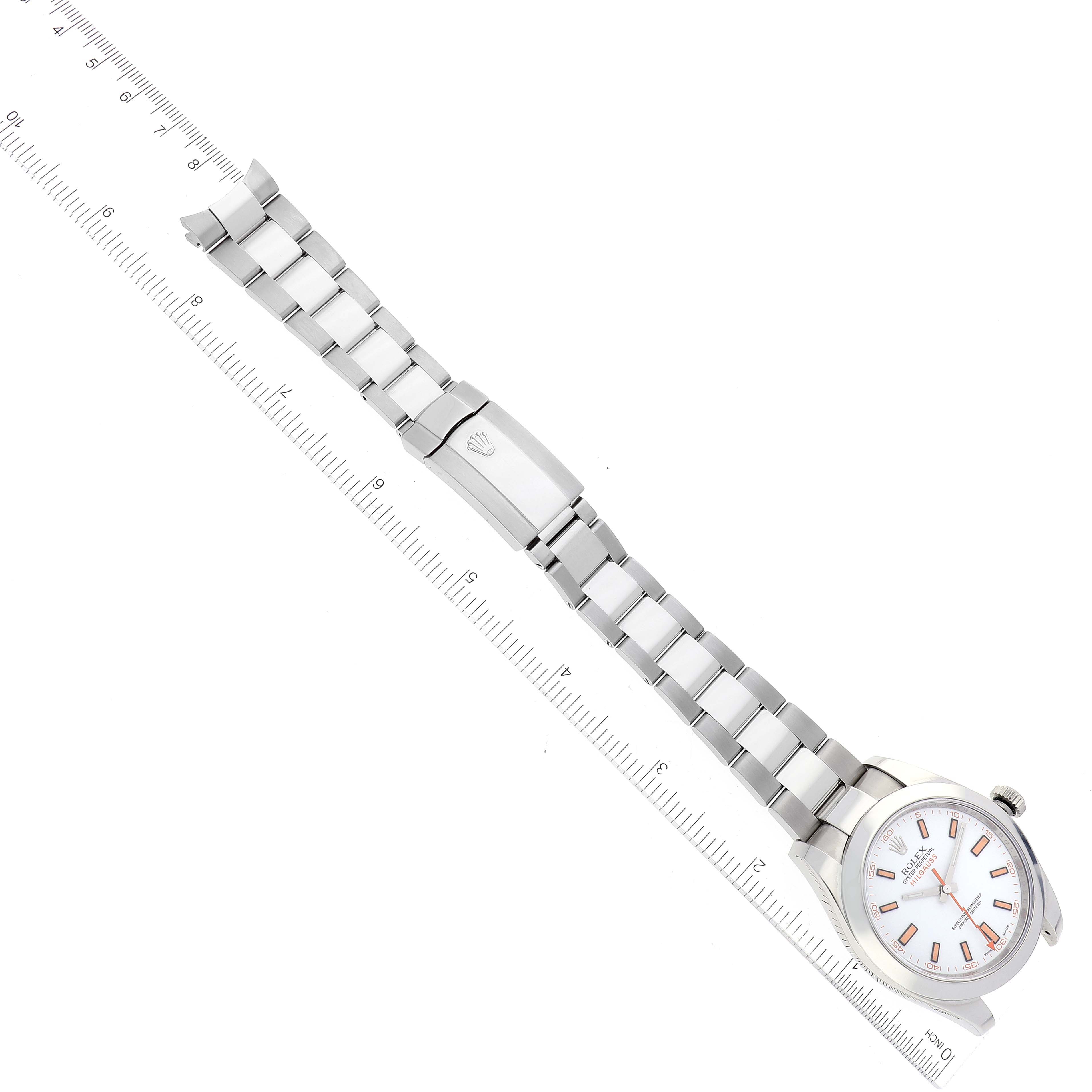 The image shows a top-down view of a Rolex Milgauss 116400 Men
s Stainless Steel White Dial 116400 Men
s Stainless Steel White Dial watch, displaying its bracelet and face, with a ruler for scale.