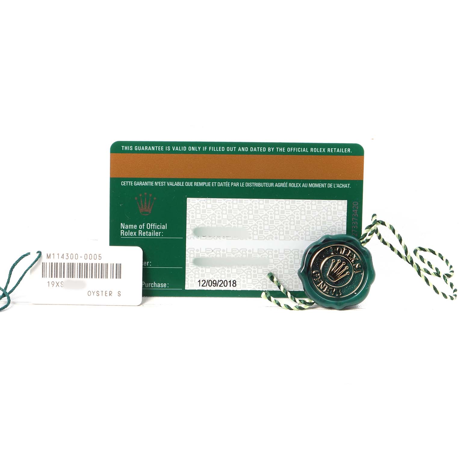 The image shows a warranty card, tag, and seal for a Rolex Oyster Perpetual 114300 Men's Stainless Steel Black Dial watch.