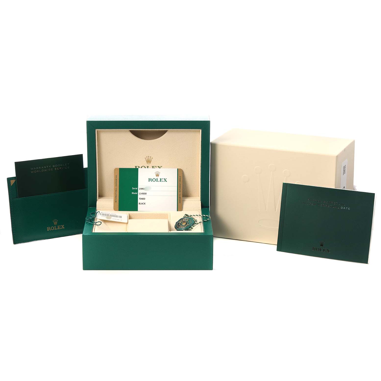 The Rolex Oyster Perpetual 114300 Men's Stainless Steel Black Dial's packaging is shown from the front, featuring the box, warranty booklet, and tags.