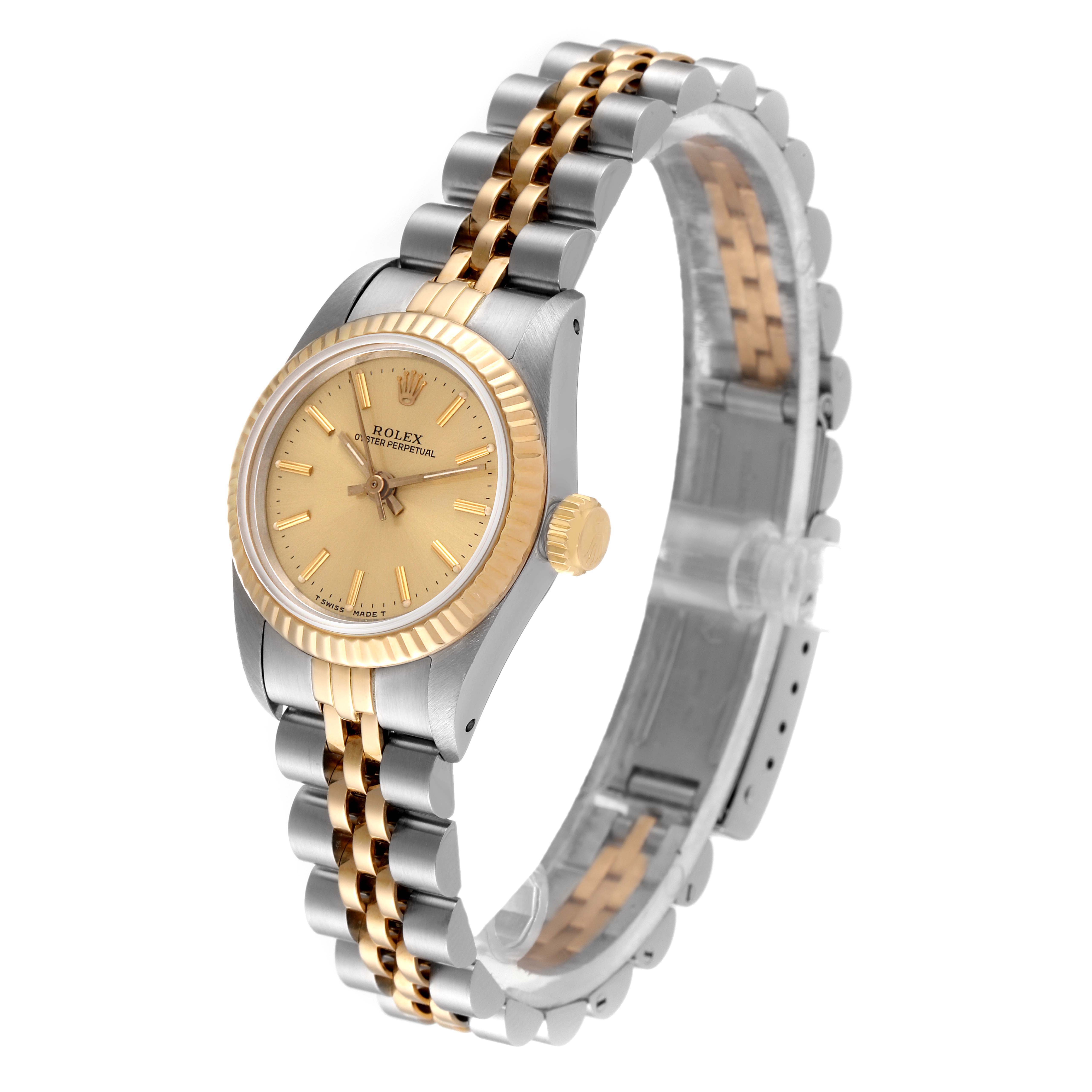 The image shows an angled view of a Rolex Oyster Perpetual 67193 Women
s Steel and Gold (two tone) Champagne Dial 67193 Women
s Steel and Gold (two tone) Champagne Dial watch featuring a two-tone metal strap and a gold bezel and dial.