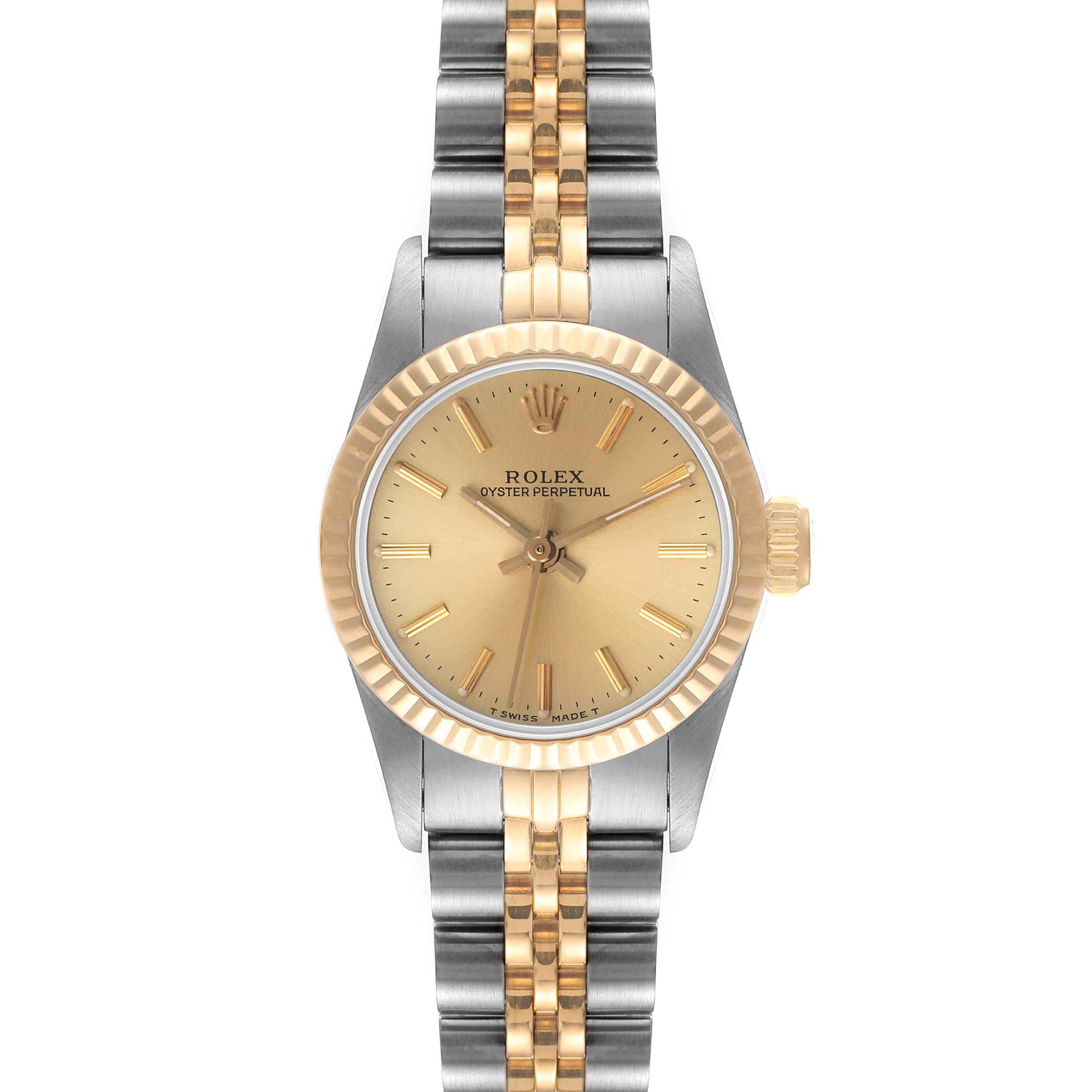 This Rolex Oyster Perpetual 67193 Women
s Steel and Gold (two tone) Champagne Dial 67193 Women
s Steel and Gold (two tone) Champagne Dial watch is shown from a frontal angle, displaying its gold dial, fluted bezel, and two-tone bracelet.