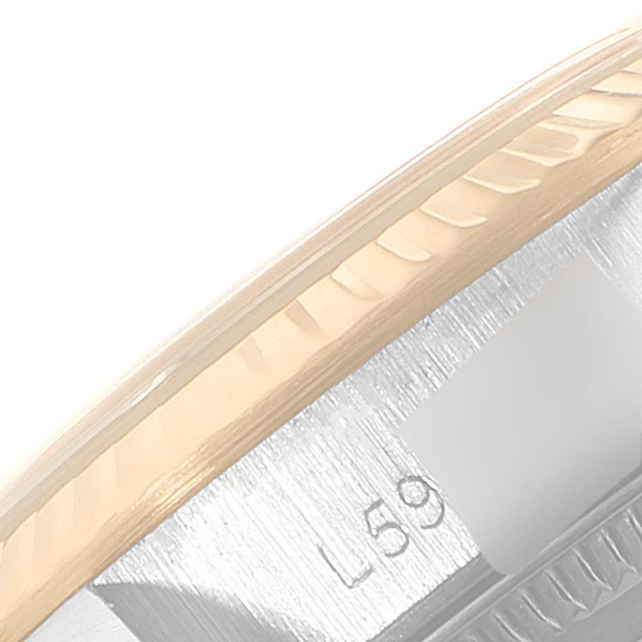 This image shows a close-up of the bezel and part of the case of a Rolex Oyster Perpetual 67193 Women
s Steel and Gold (two tone) Champagne Dial 67193 Women
s Steel and Gold (two tone) Champagne Dial watch.