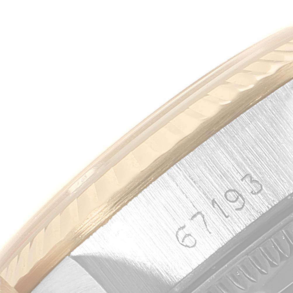 This close-up image shows the side of the case and the bezel of the Rolex Oyster Perpetual 67193 Women
s Steel and Gold (two tone) Champagne Dial 67193 Women
s Steel and Gold (two tone) Champagne Dial watch, highlighting the model number 67193.