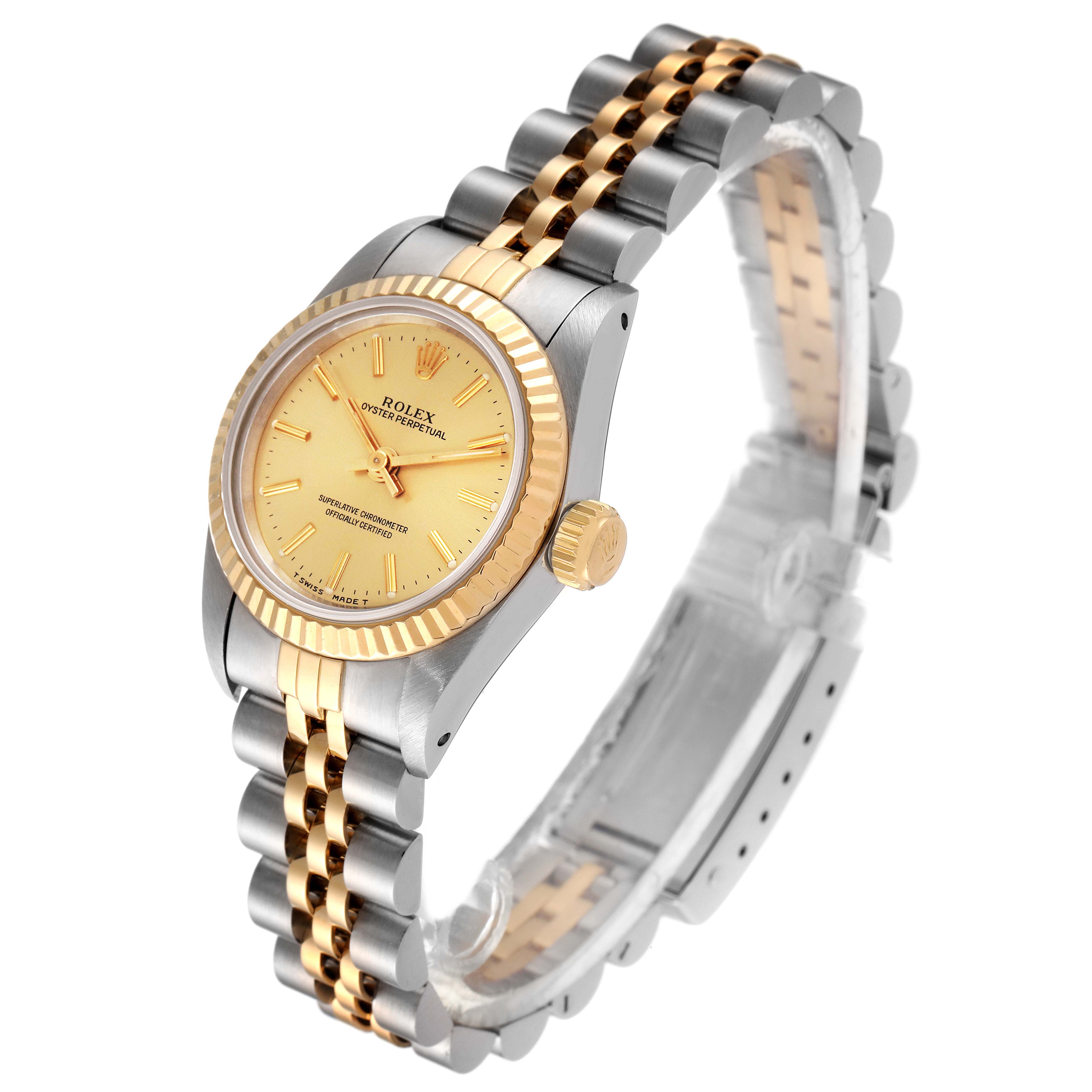 The Rolex Oyster Perpetual 67193 Women
s Steel and Gold (two tone) Champagne Dial 67193 Women
s Steel and Gold (two tone) Champagne Dial watch is shown at a three-quarter angle, highlighting the bezel, crown, dial, and bracelet.