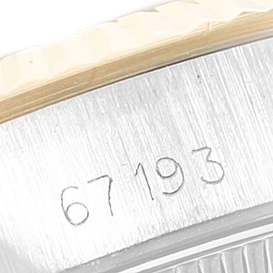 The image shows a close-up of the case side and engraving on a Rolex Oyster Perpetual 67193 Women
s Steel and Gold (two tone) Champagne Dial 67193 Women
s Steel and Gold (two tone) Champagne Dial model watch.